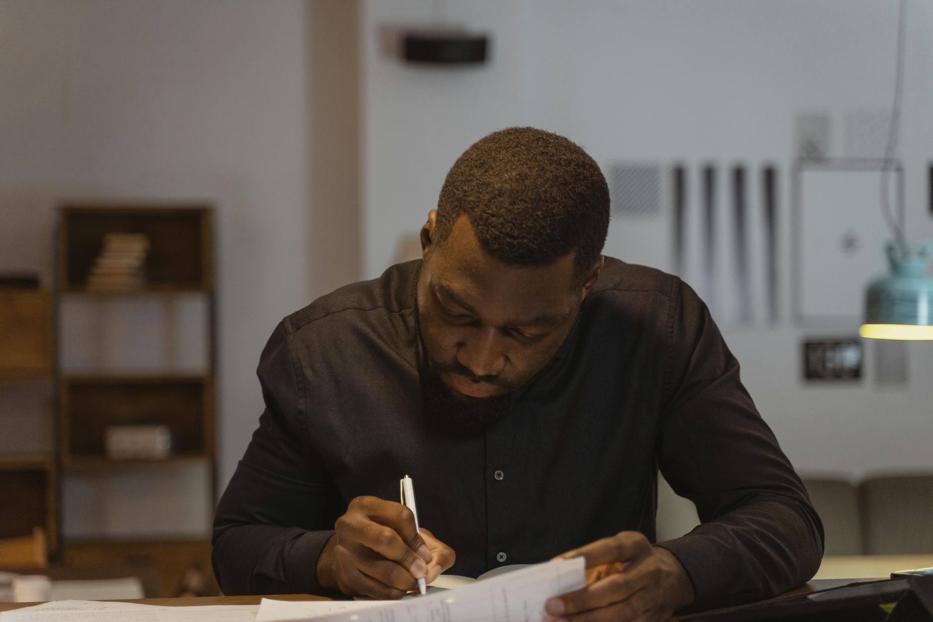 A judge observing a debate, taking notes with a focused expression. — debate judging