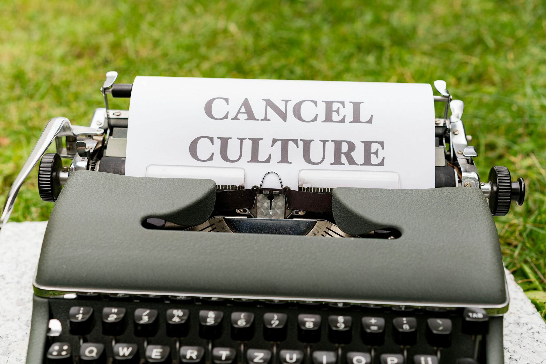 A photo of a protest highlighting different viewpoints on cancel culture.