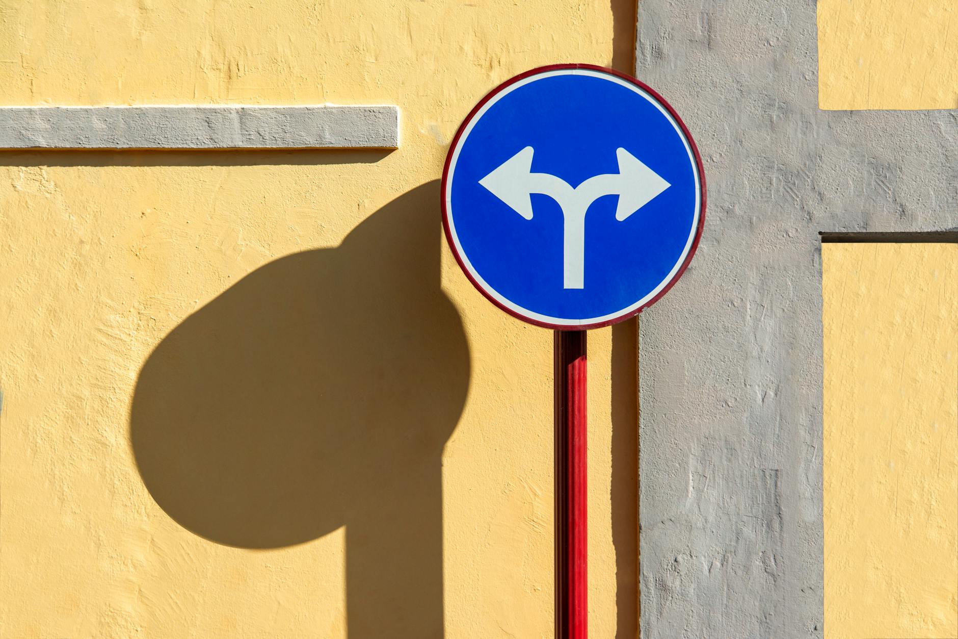 A visual representation of an ethical dilemma, such as a crossroads sign symbolizing moral choices. — ethical debates