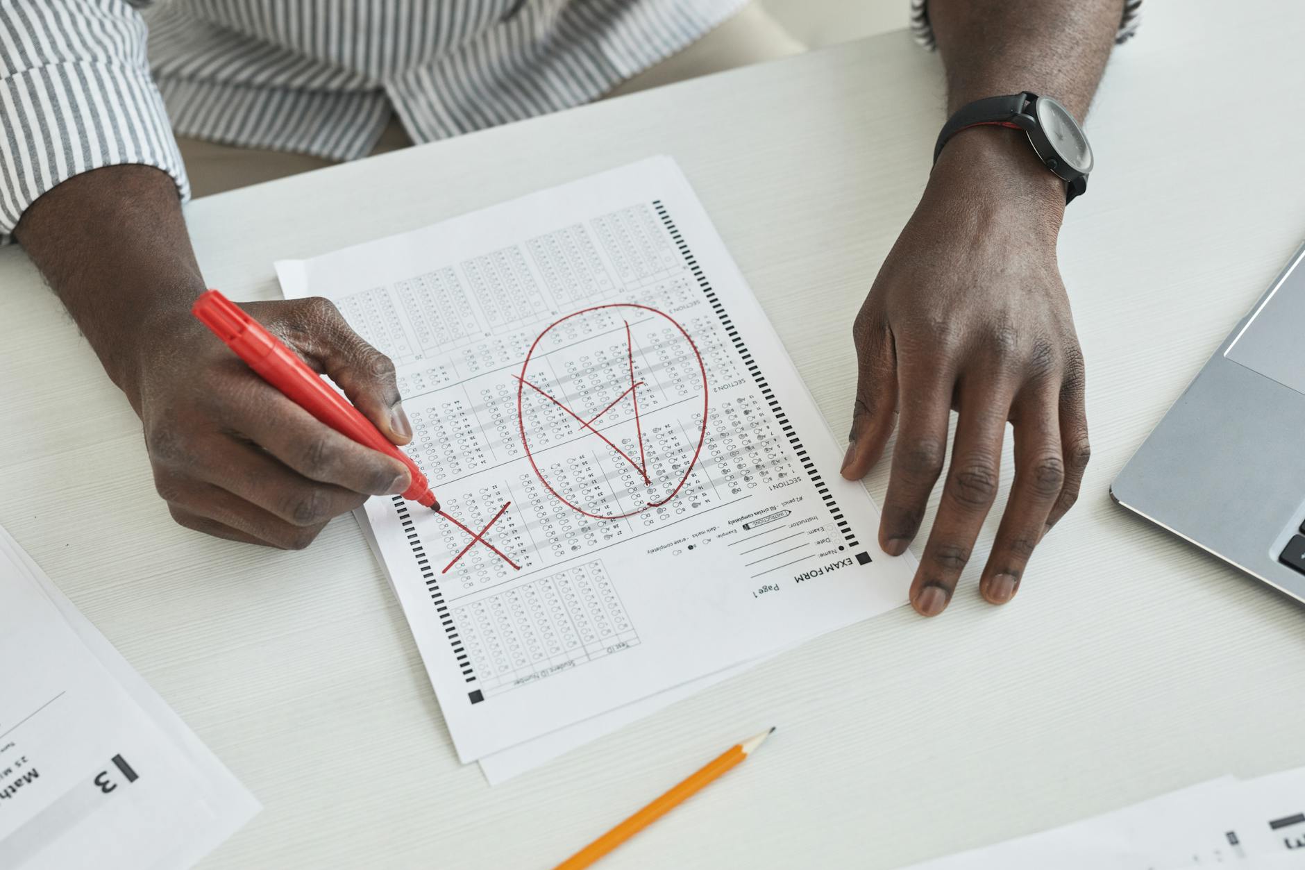 An image of a debate judge evaluating a round, with notes and score sheets in hand. — debate judging