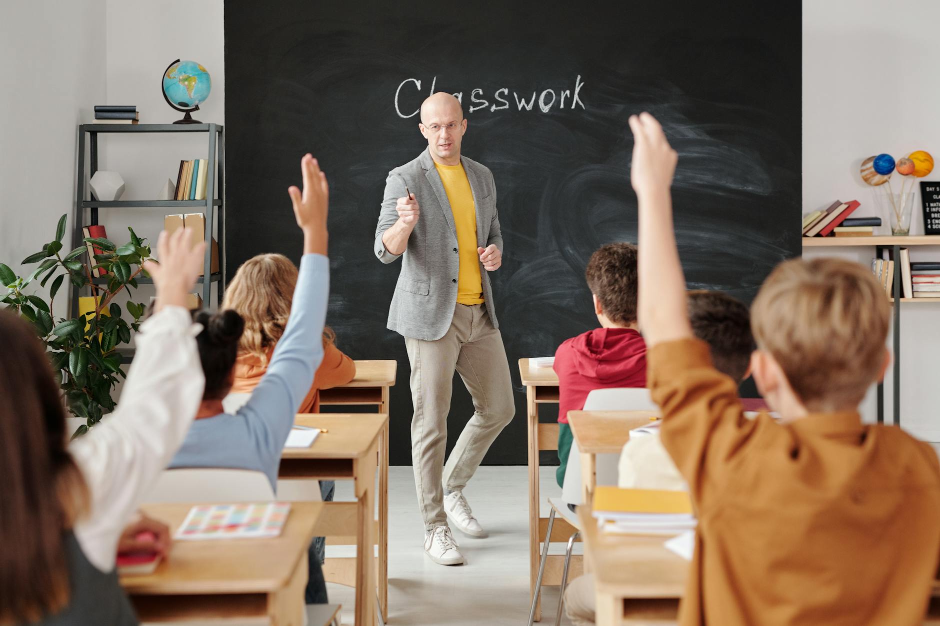 A classroom setting showing traditional education methods with students and a teacher.