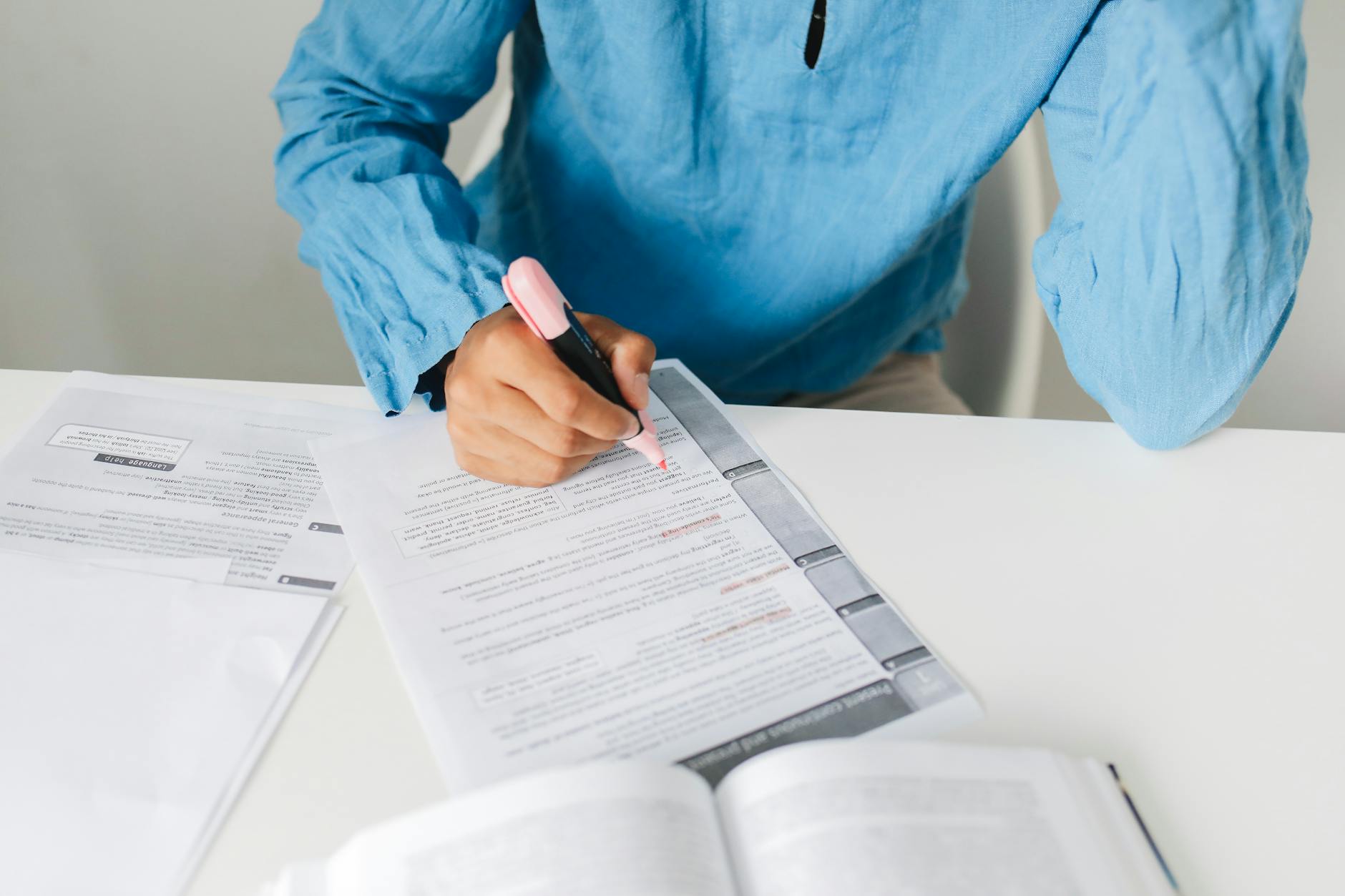 A close-up of a person reviewing notes and visual aids while preparing for a high-stakes debate. — debate preparation