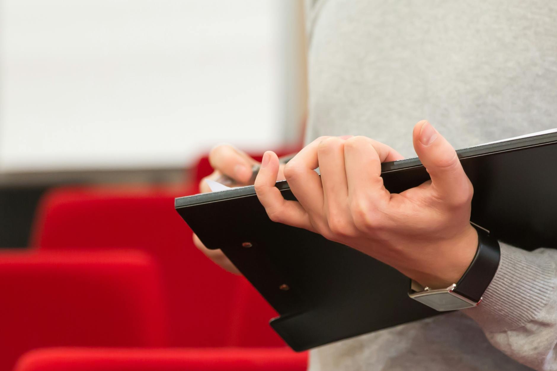 A close-up of participants preparing their notes before a debate competition. — debate clubs