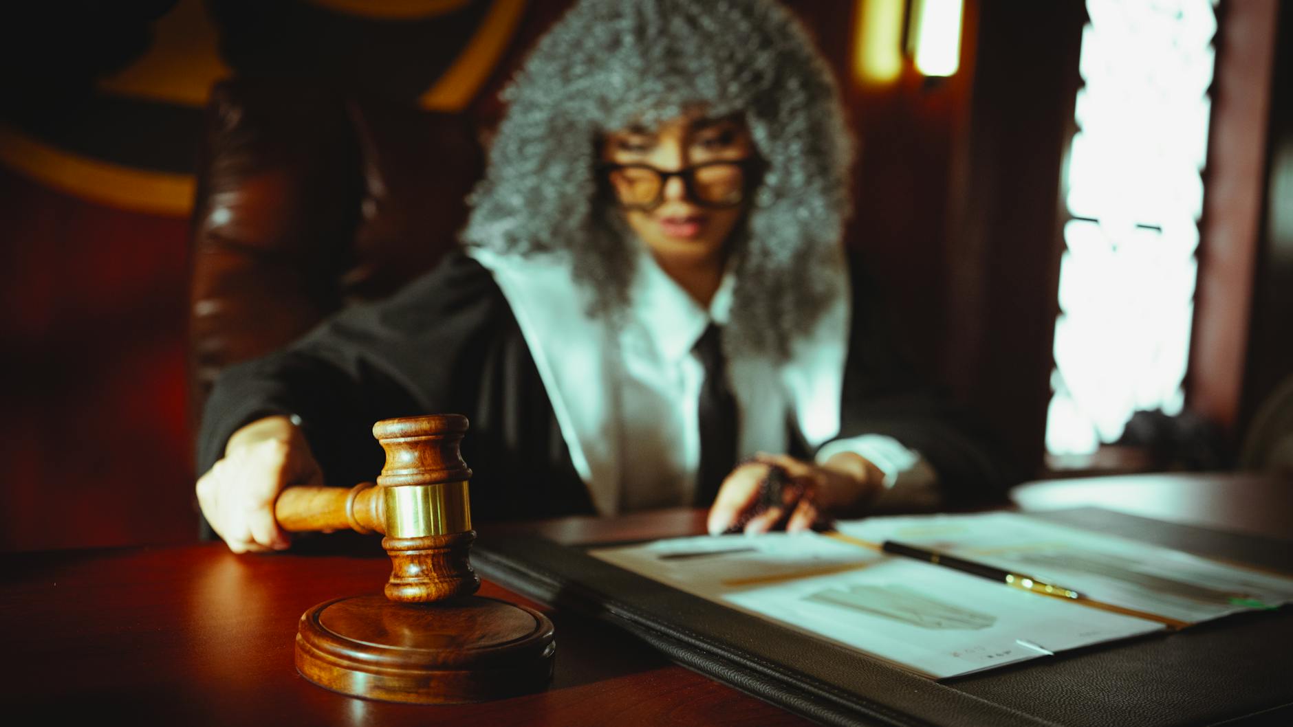 A diverse group of judges seated at a debate competition, engaged in judging. — debate judging