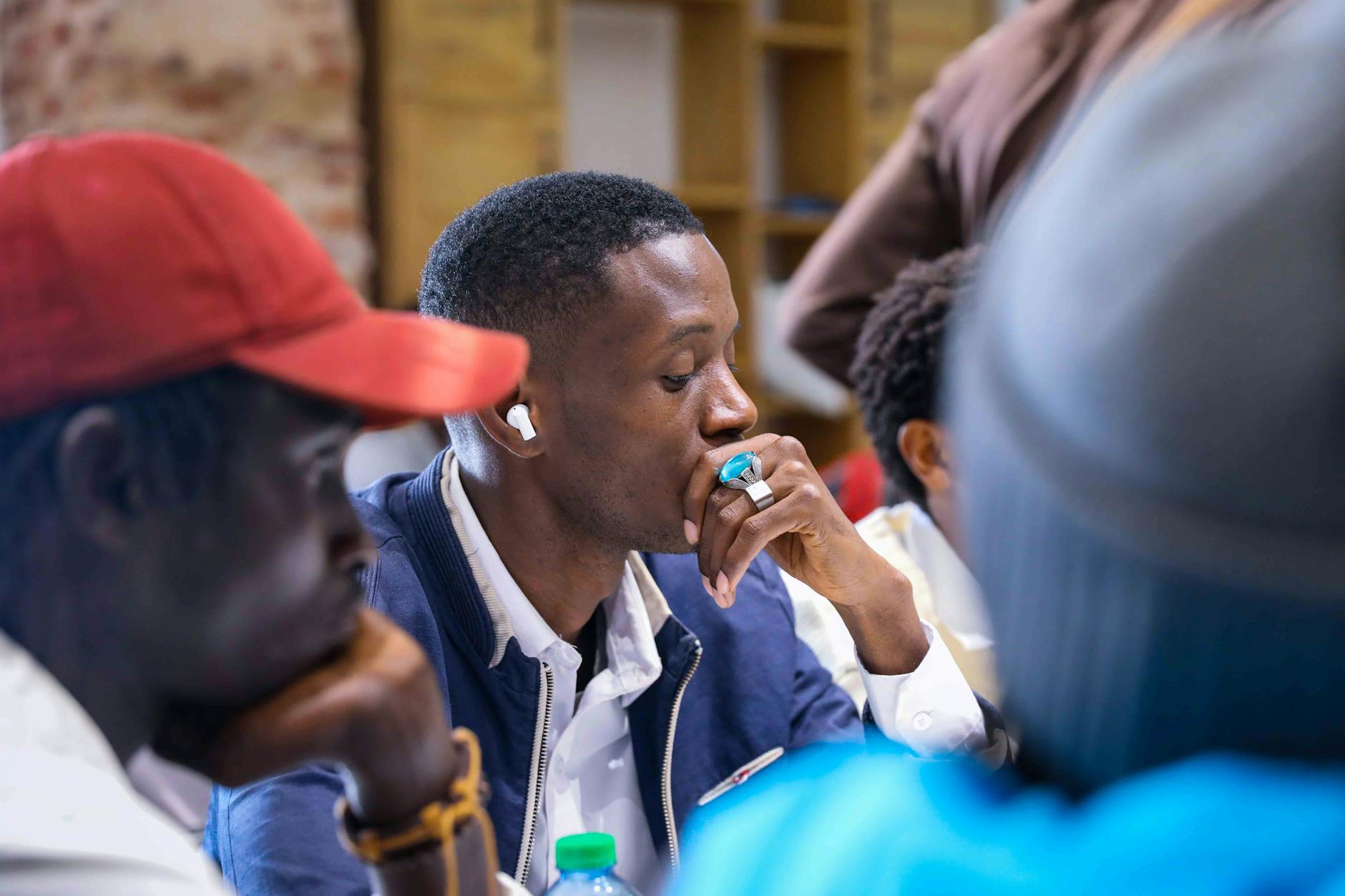 A diverse group of people engaged in a discussion about climate change, showcasing active listening. — climate change de…