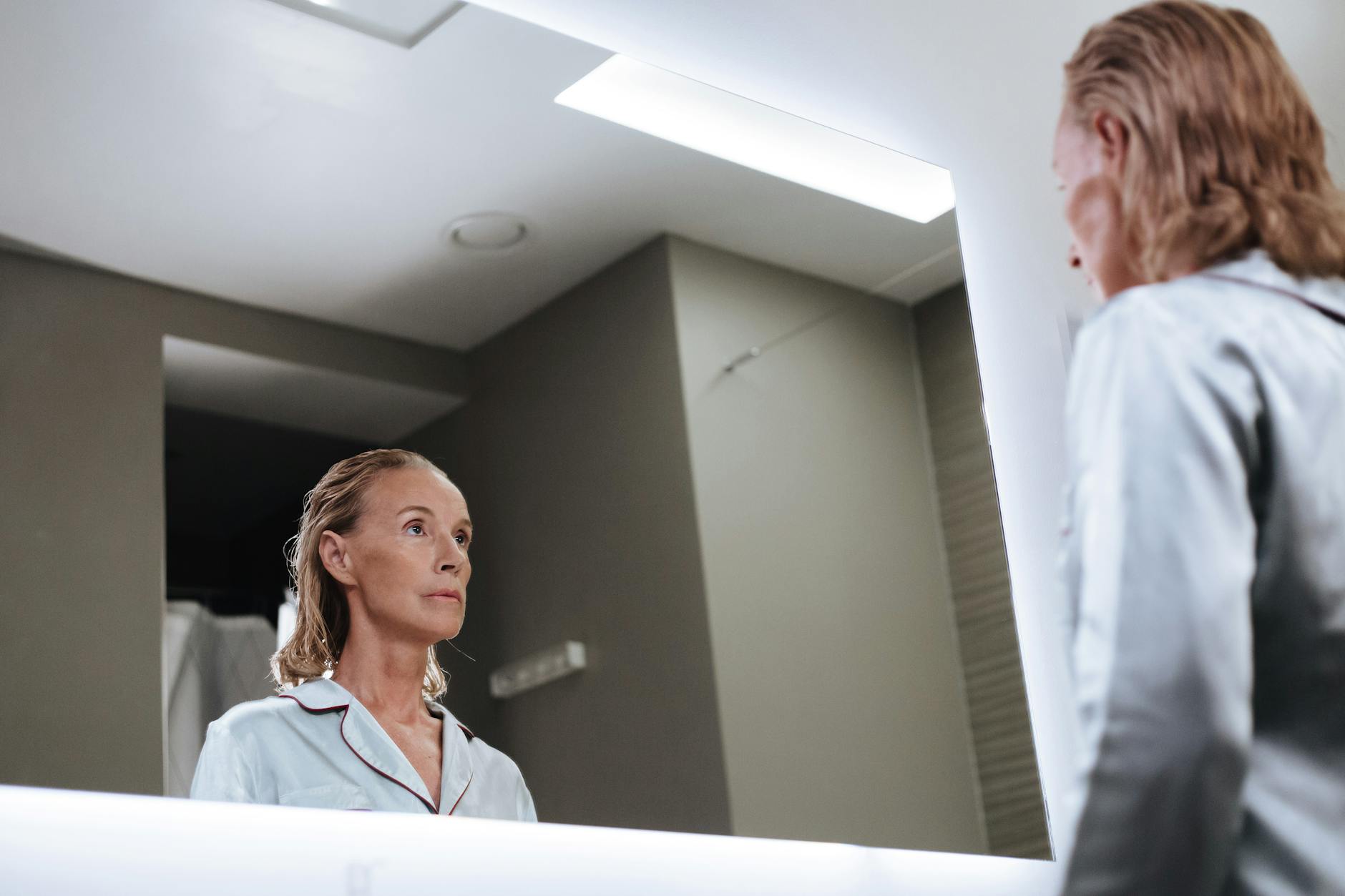 A person practicing their debate skills in front of a mirror, demonstrating self-reflection and preparation.