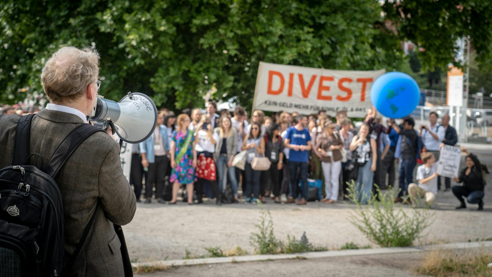A photo of a community climate action event, showcasing people engaged in discussions and activities related to climate ch…