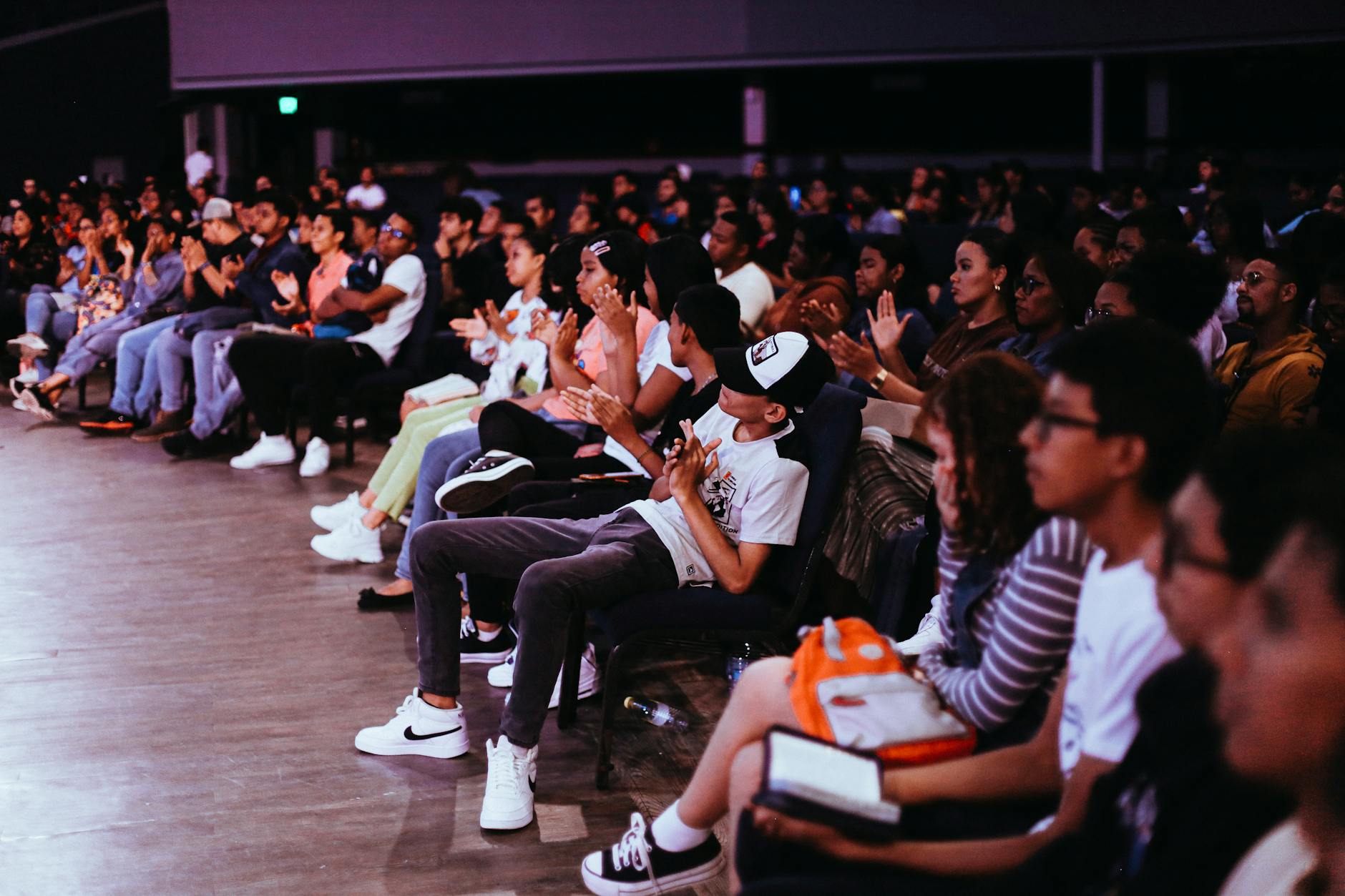 A photo of a diverse audience engaged in a debate, highlighting audience psychology. — debate psychology
