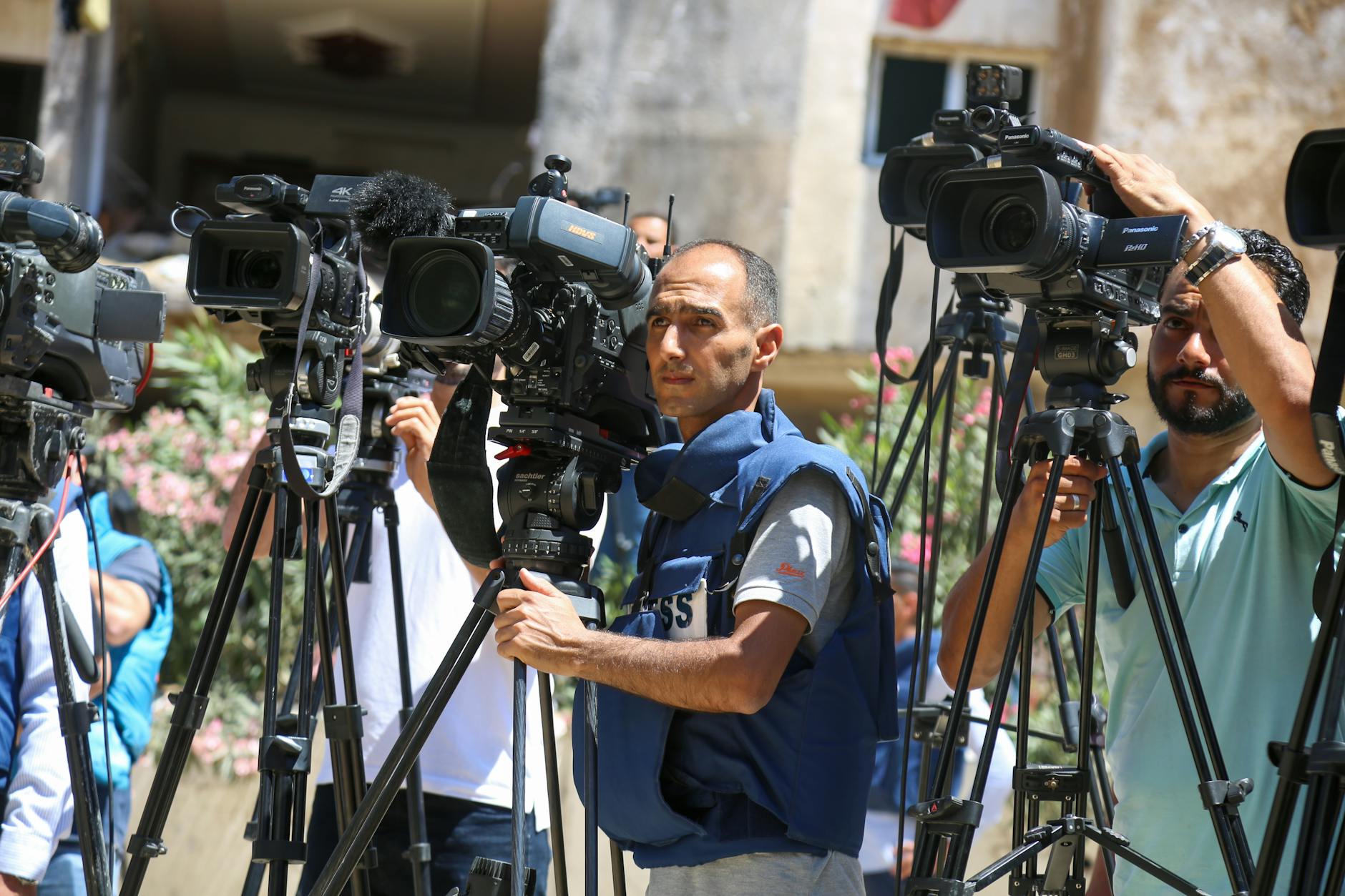 A photo of journalists in the field, capturing the challenges they face in reporting conflict news during the war media censorship debate.