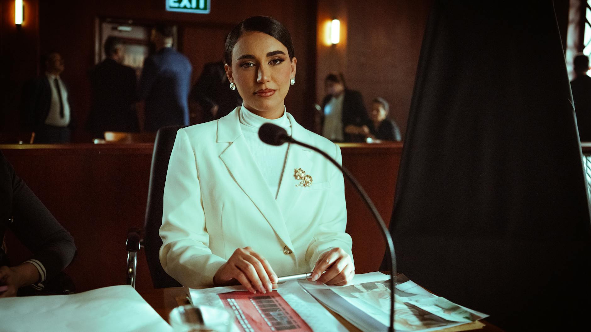 An experienced debate judge reviewing notes and scoring a debate round. — debate judging