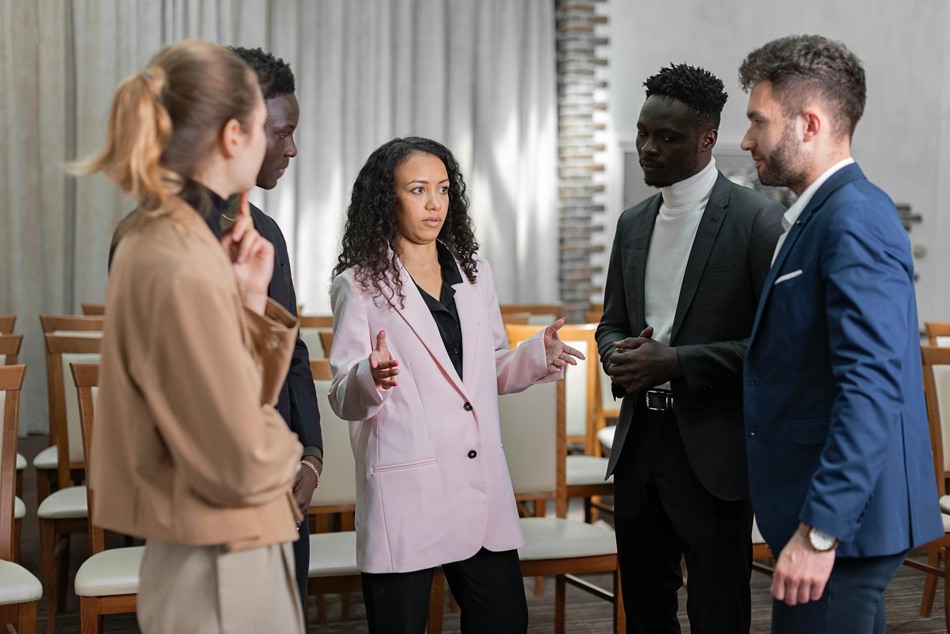 An image depicting a diverse group of professionals engaged in a debate during a meeting, showcasing active listening and …