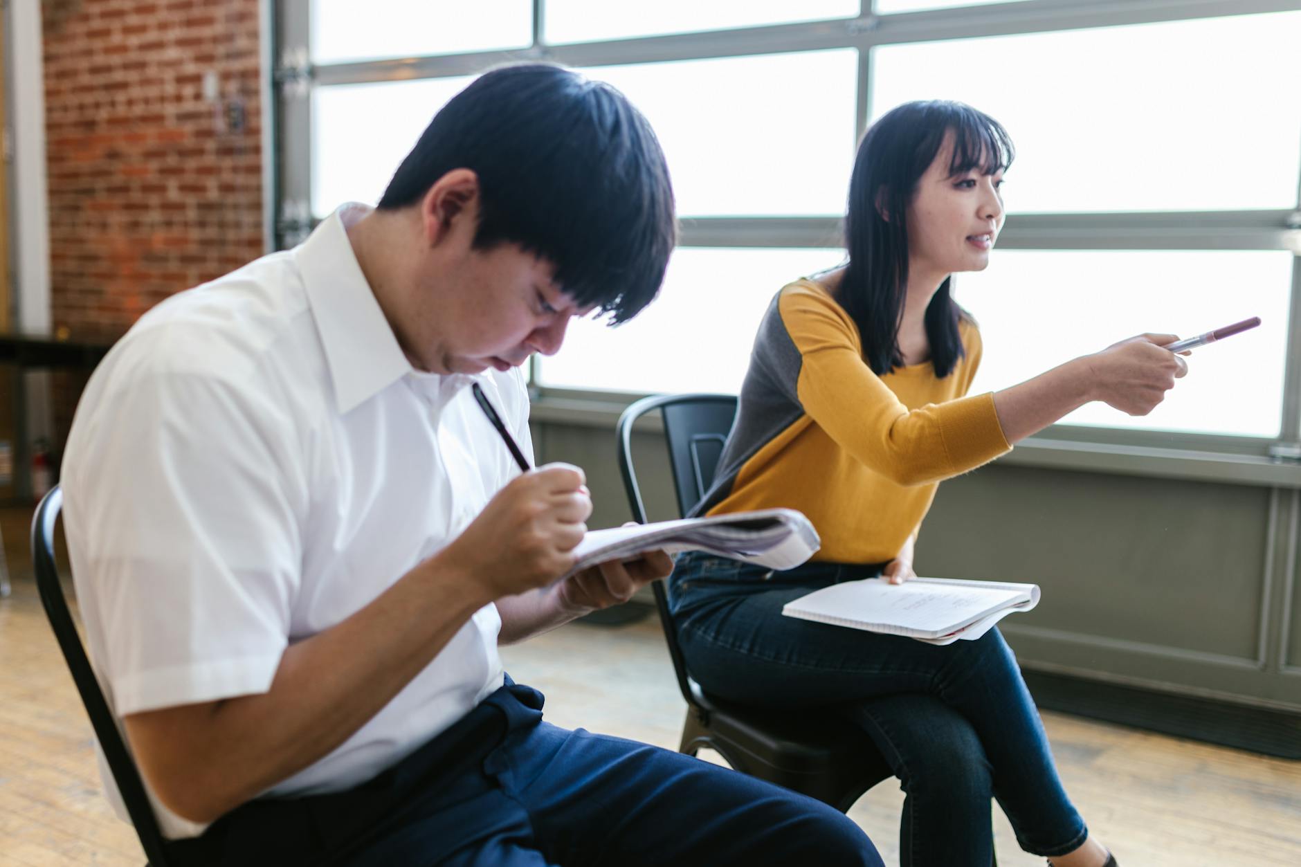 An image depicting a mock debate session with participants engaging and taking notes. — debate preparation