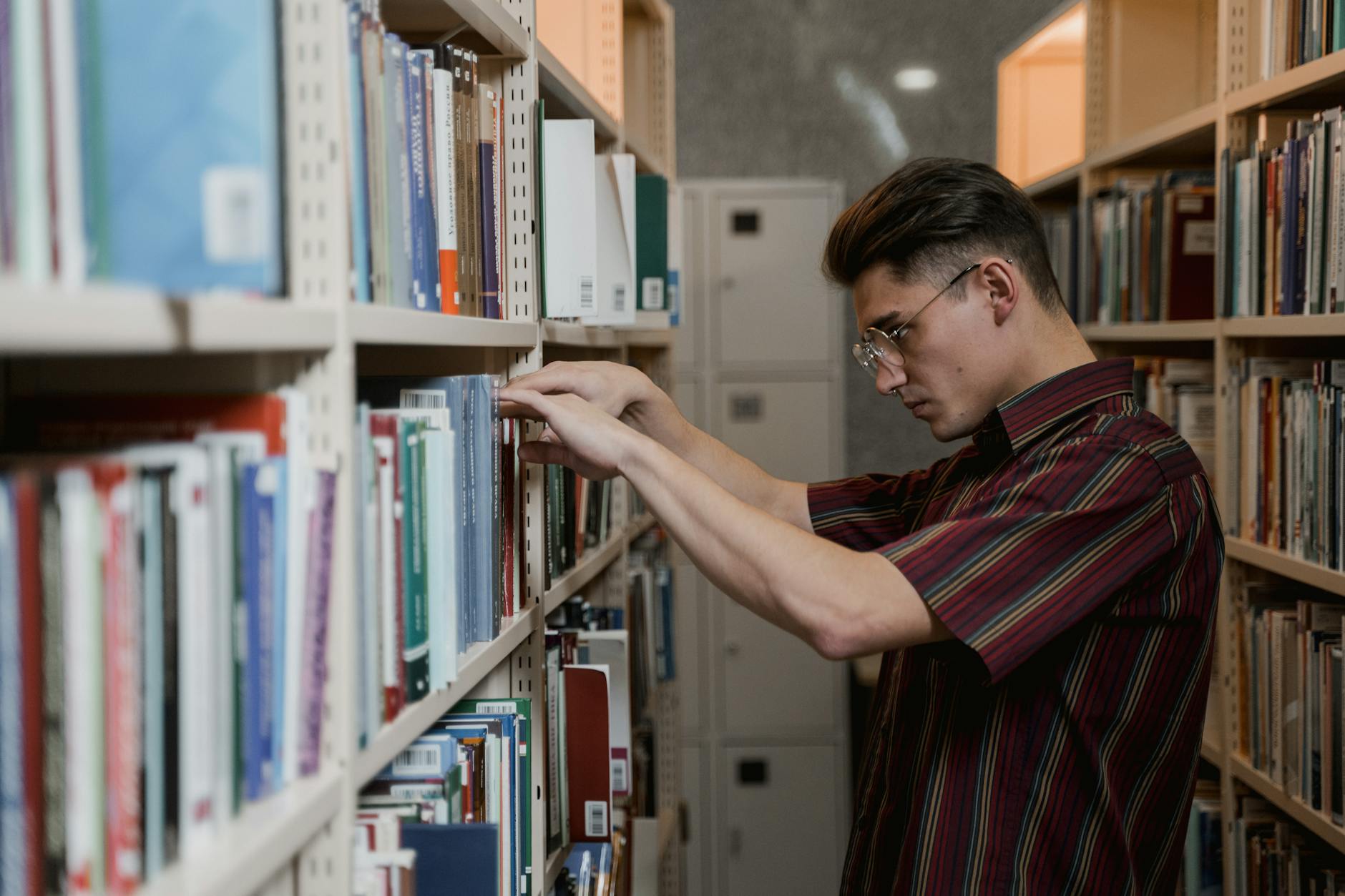 An image of a student researching debate topics at a library, representing the gathering of information for debate preparation.