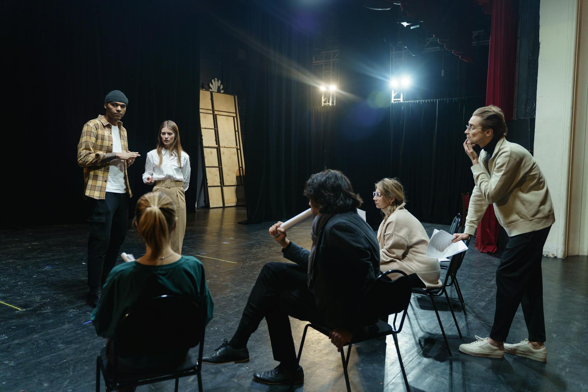 An image showing a group of people practicing debating techniques in a workshop.