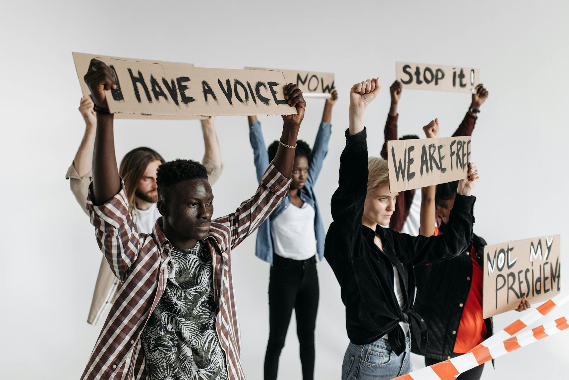 Image showing a protest against cancel culture with diverse individuals holding signs advocating for social justice.