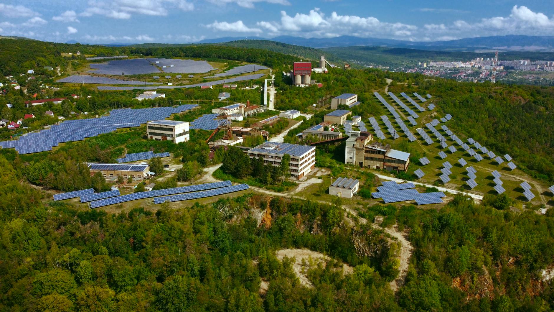 Photo of a solar farm with a city skyline in the background, symbolizing sustainable development. — climate change debate