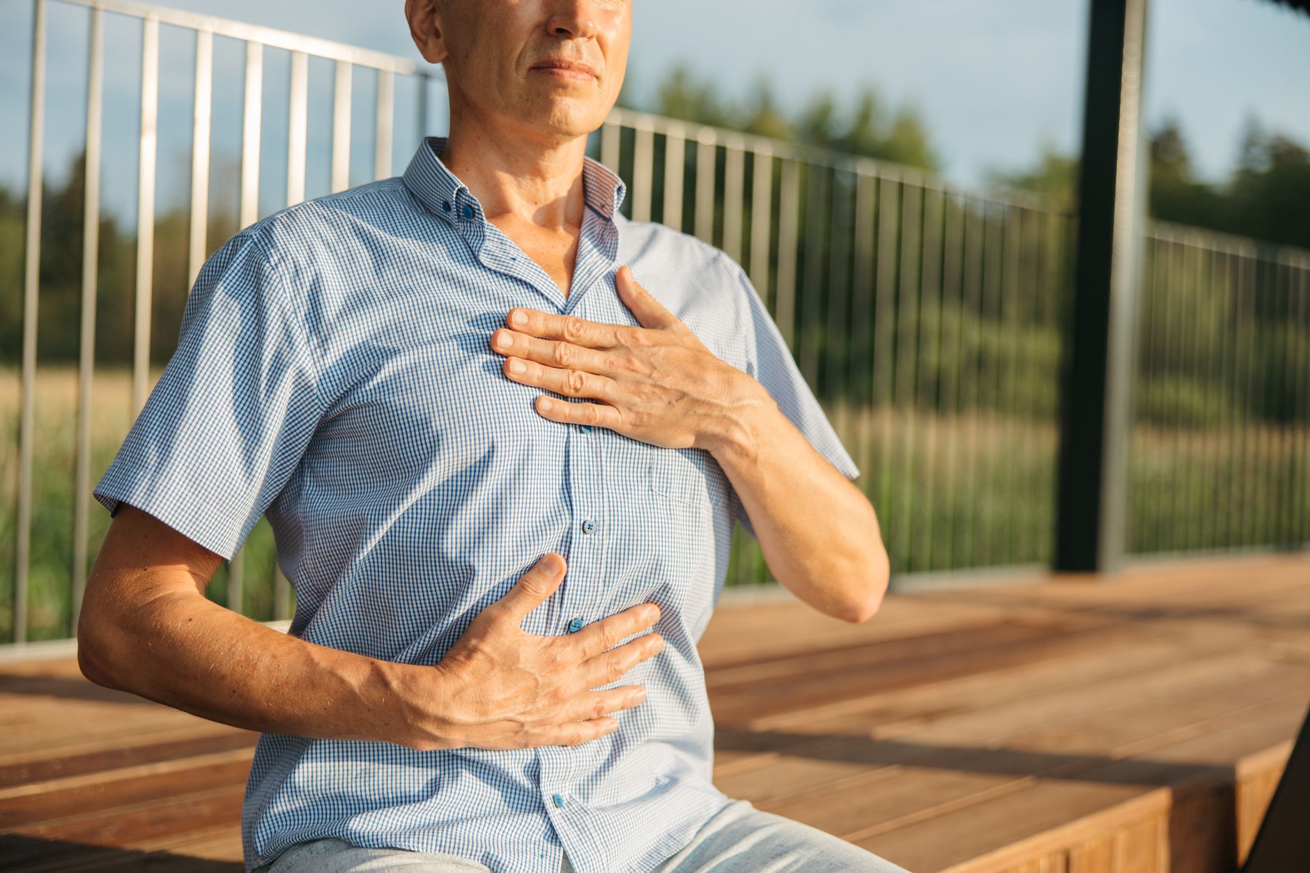 A calm individual taking deep breaths as a technique for maintaining composure during a debate. — handling disagreements