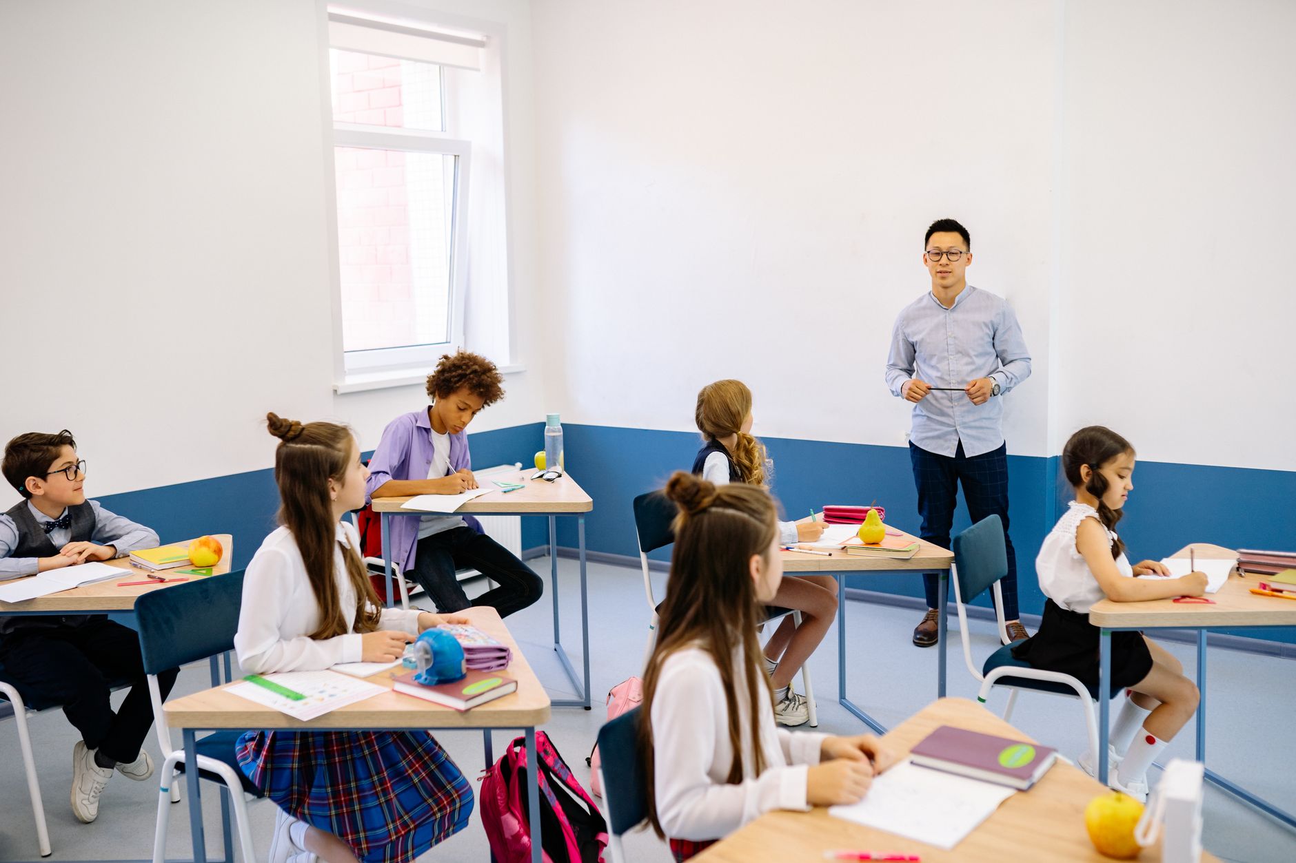 A classroom filled with diverse students engaged in learning. — college free debate