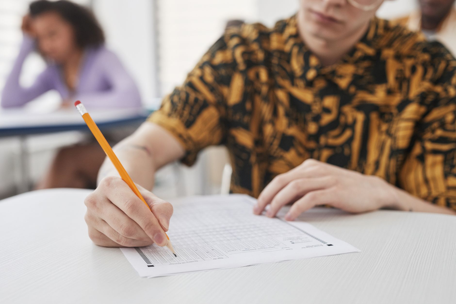 A classroom scene depicting students engaged in a standardized test — education reform debate