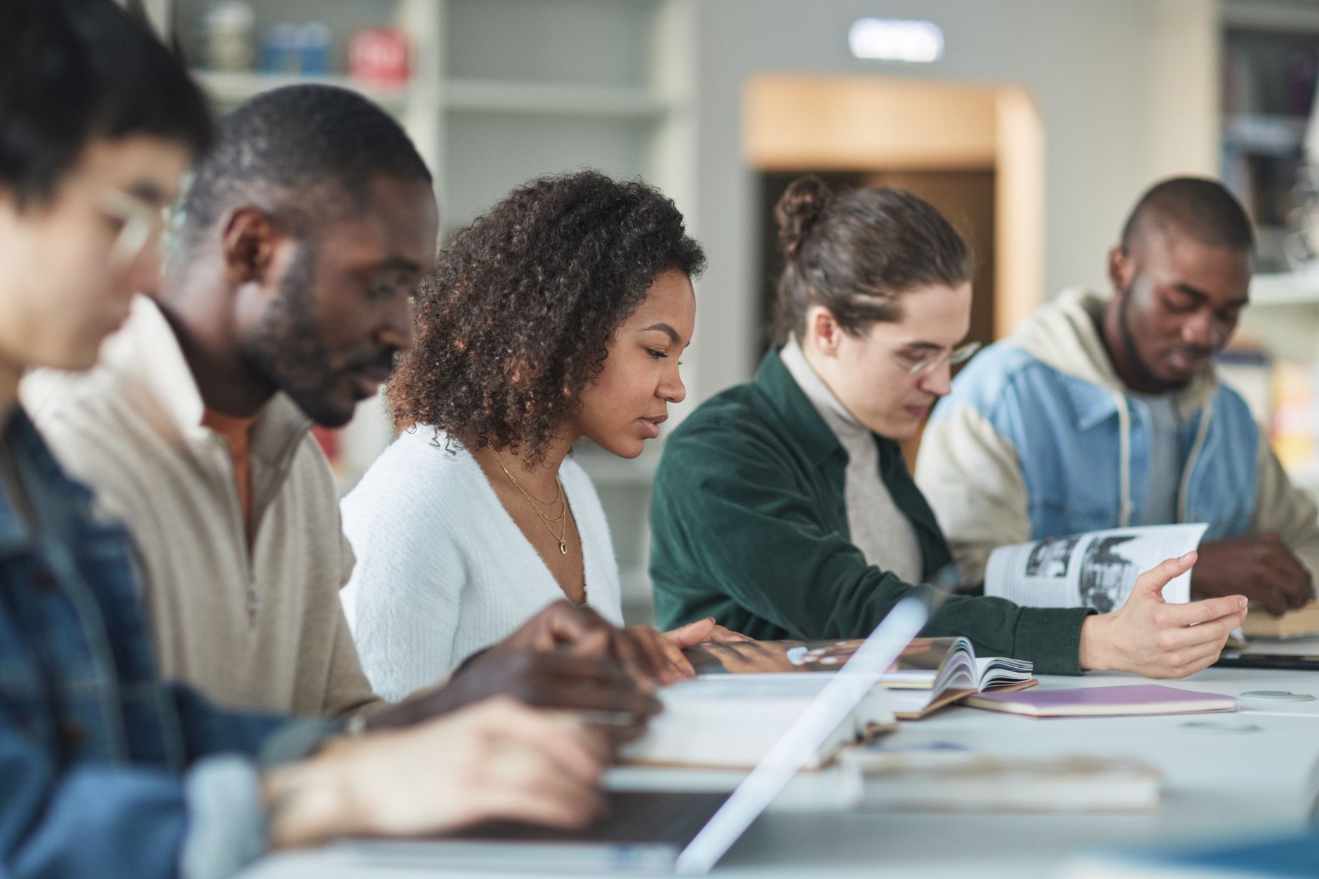 A diverse group of students studying together in a college environment. — free education debate
