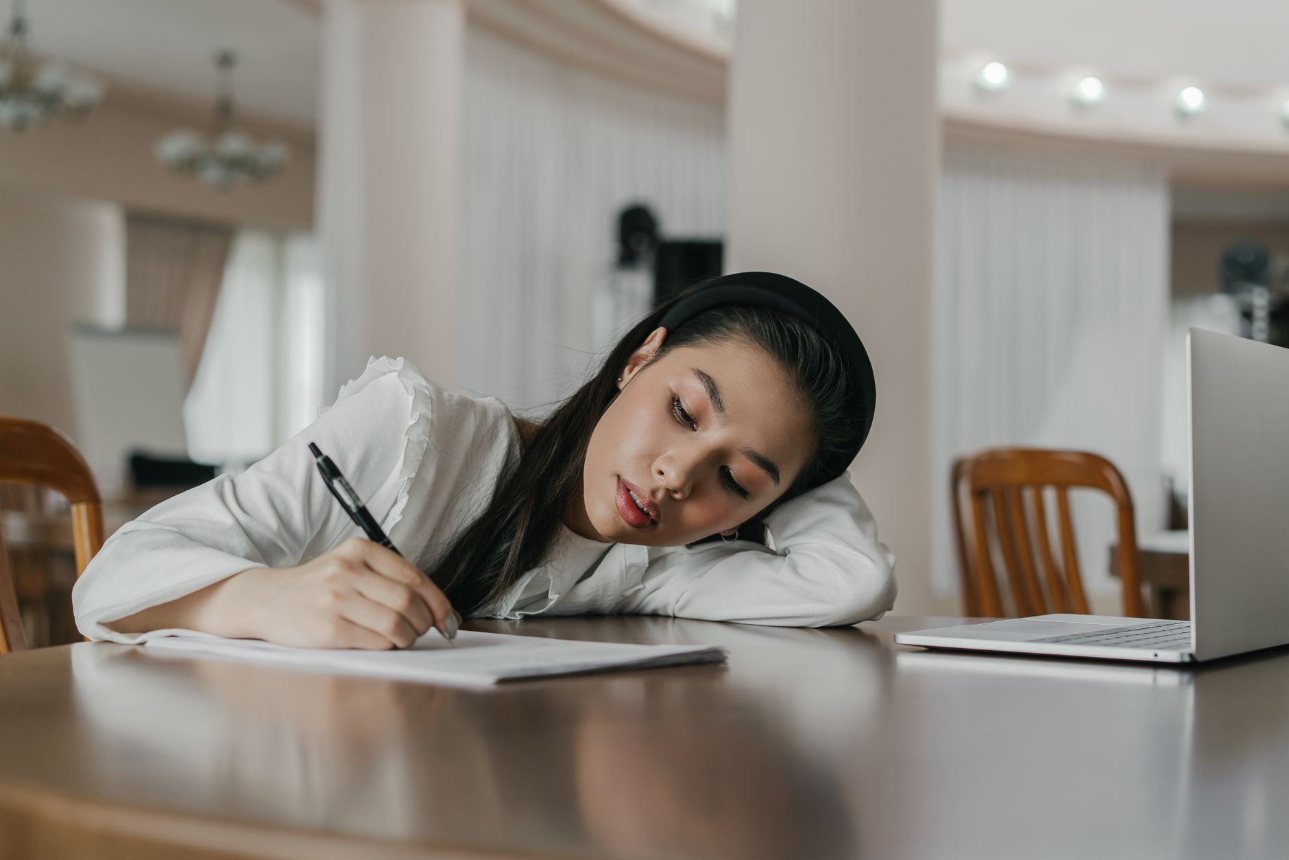 A focused student reviewing debate notes with a laptop, illustrating preparation techniques. — debate preparation tips
