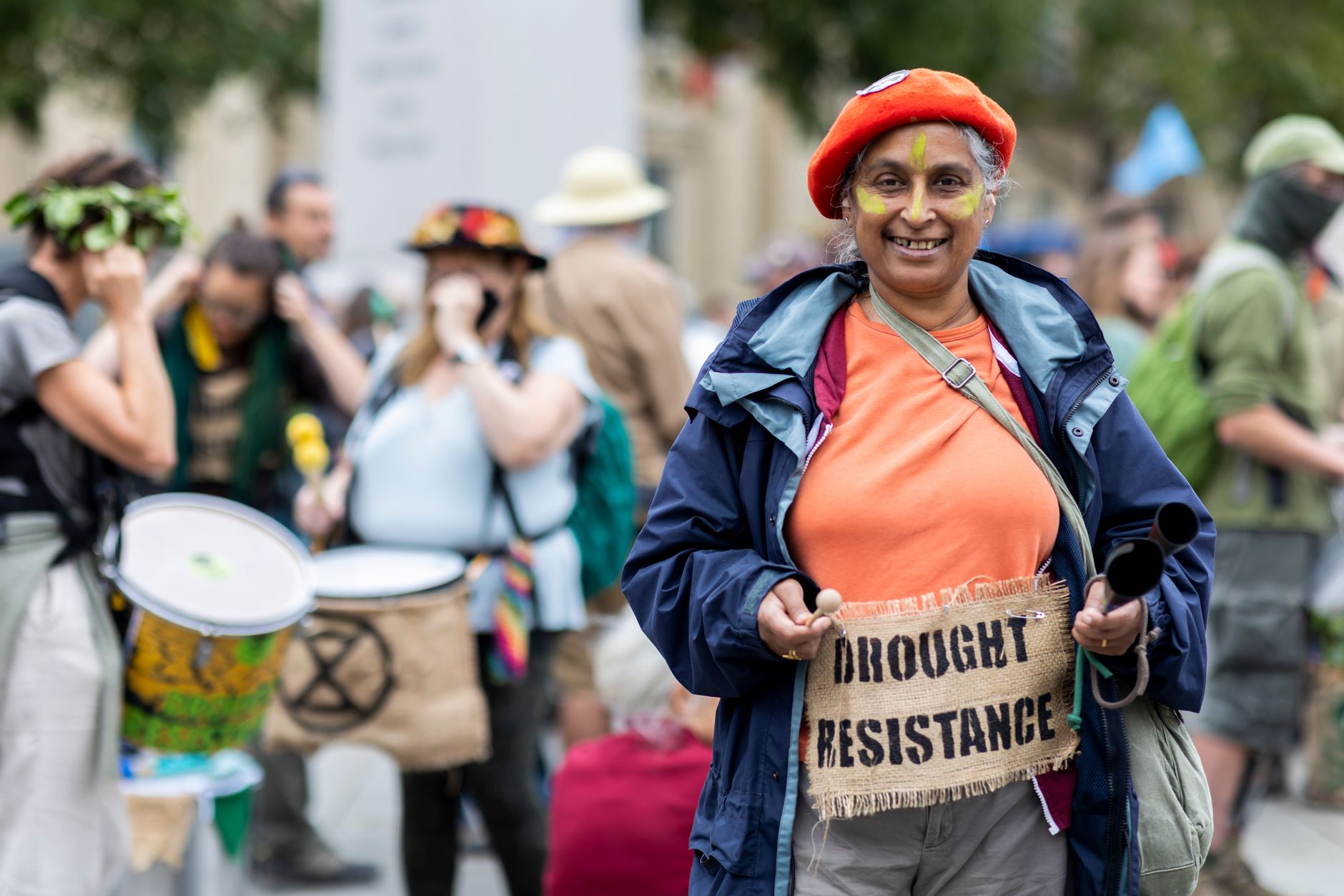 A group of diverse individuals participating in a climate march, symbolizing community engagement in solutions to the climate change debate.