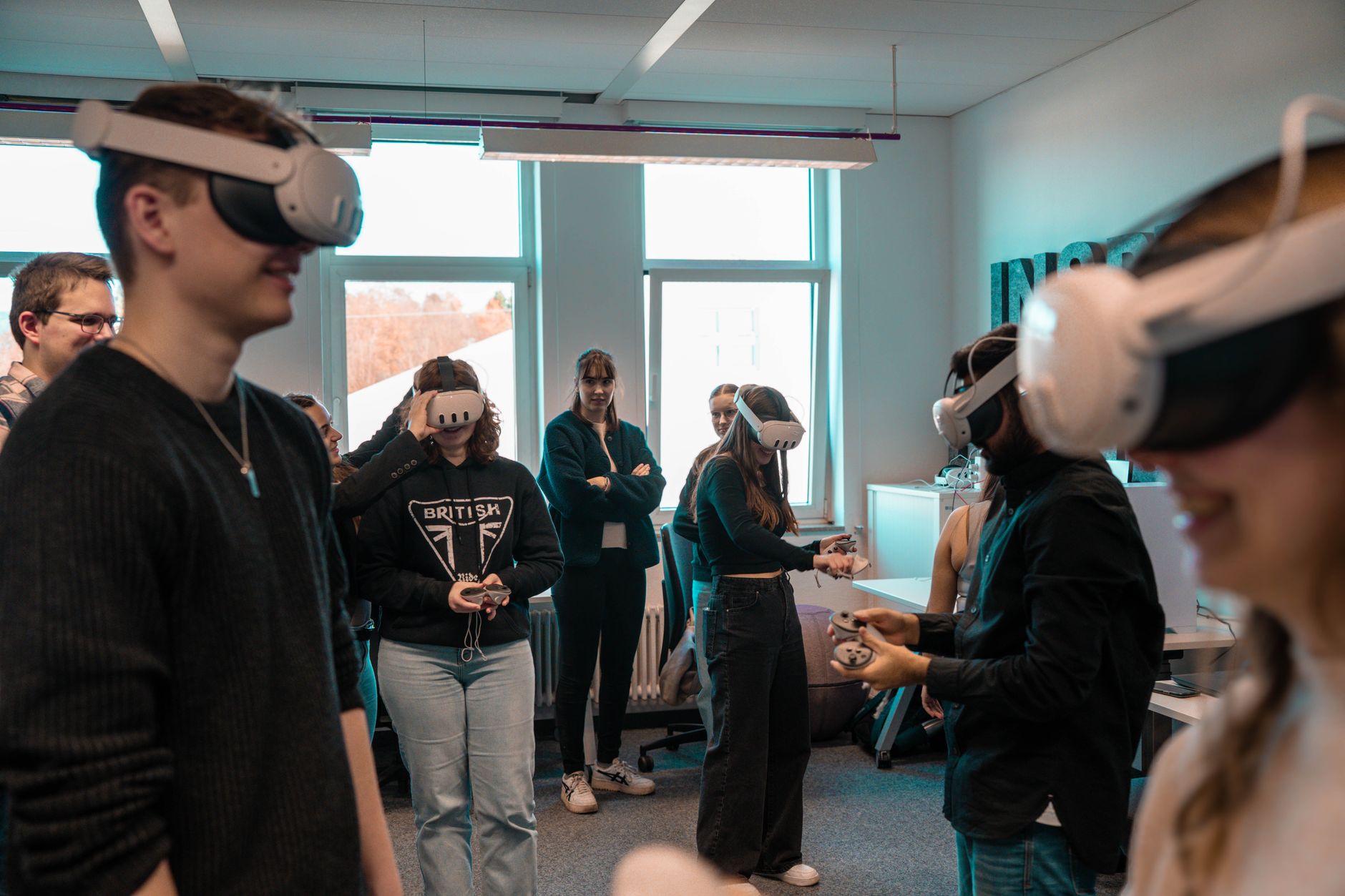 A group of students participating in a virtual reality debate session using headsets and immersive environments. — techn…