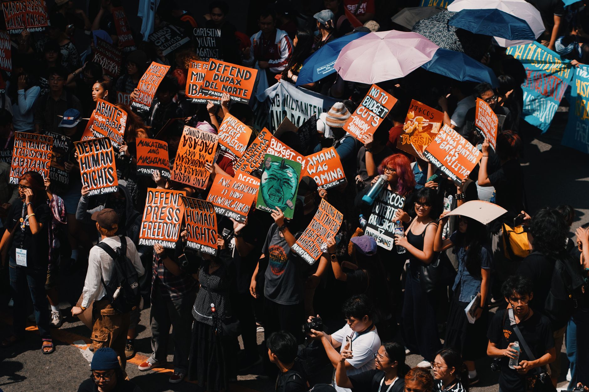A large crowd of climate activists holding signs during a protest. — climate activism