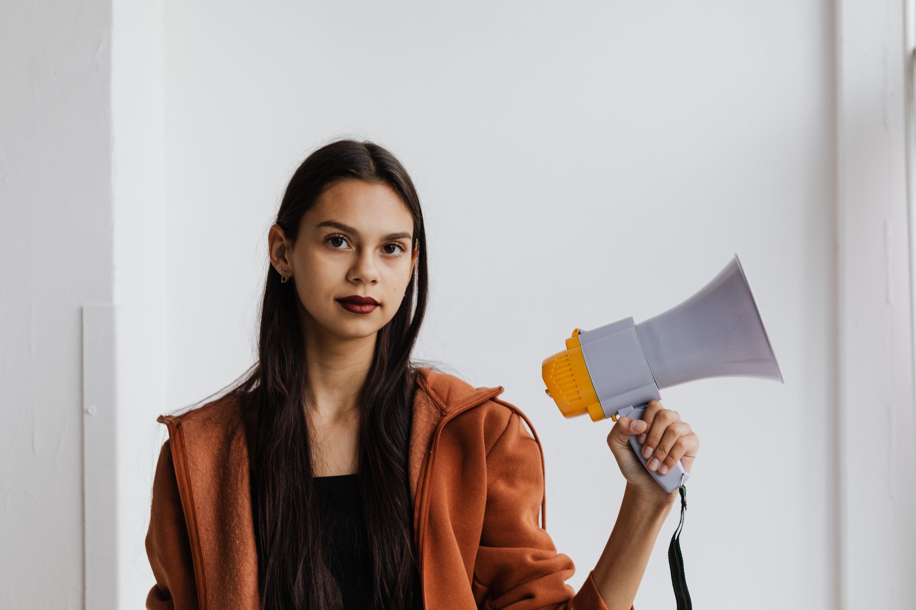 A modern beauty pageant contestant speaking at a social issue forum, highlighting empowerment. — beauty pageants debate