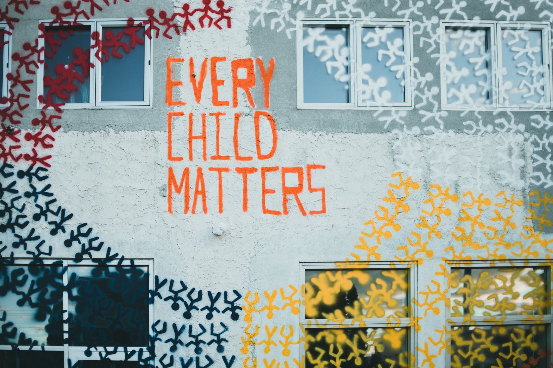 A mural depicting social justice themes in an urban setting, showcasing community engagement. — art and social change