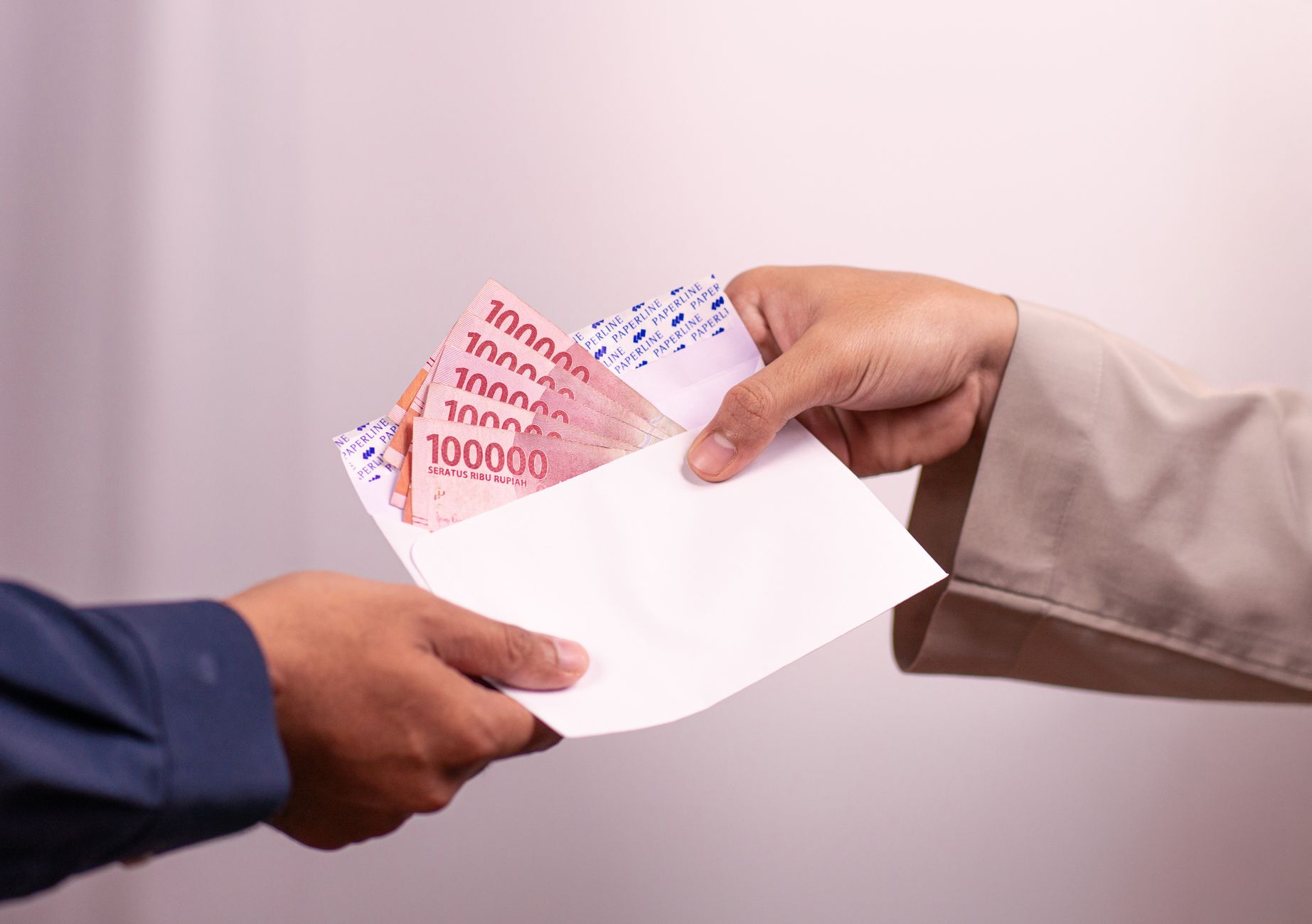 A photo of a UBI trial in action, featuring participants receiving funds. — universal basic income