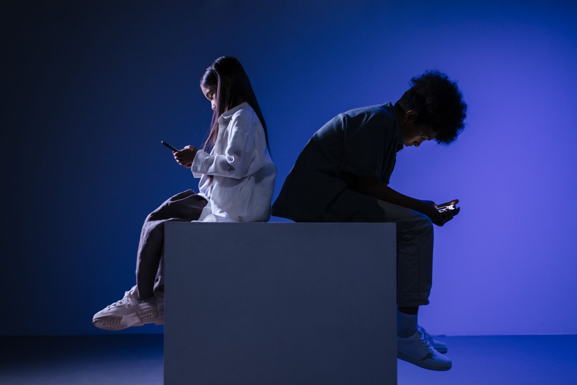 A photo of people engaged in outdoor activities, contrasting with those using devices indoors — technology laziness debate
