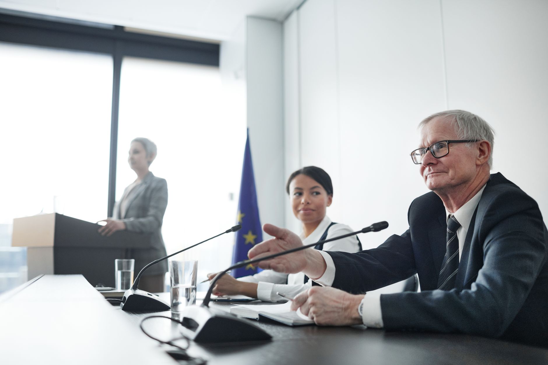 A photograph of a climate change policy meeting with scientists and policymakers discussing strategies. — climate change…