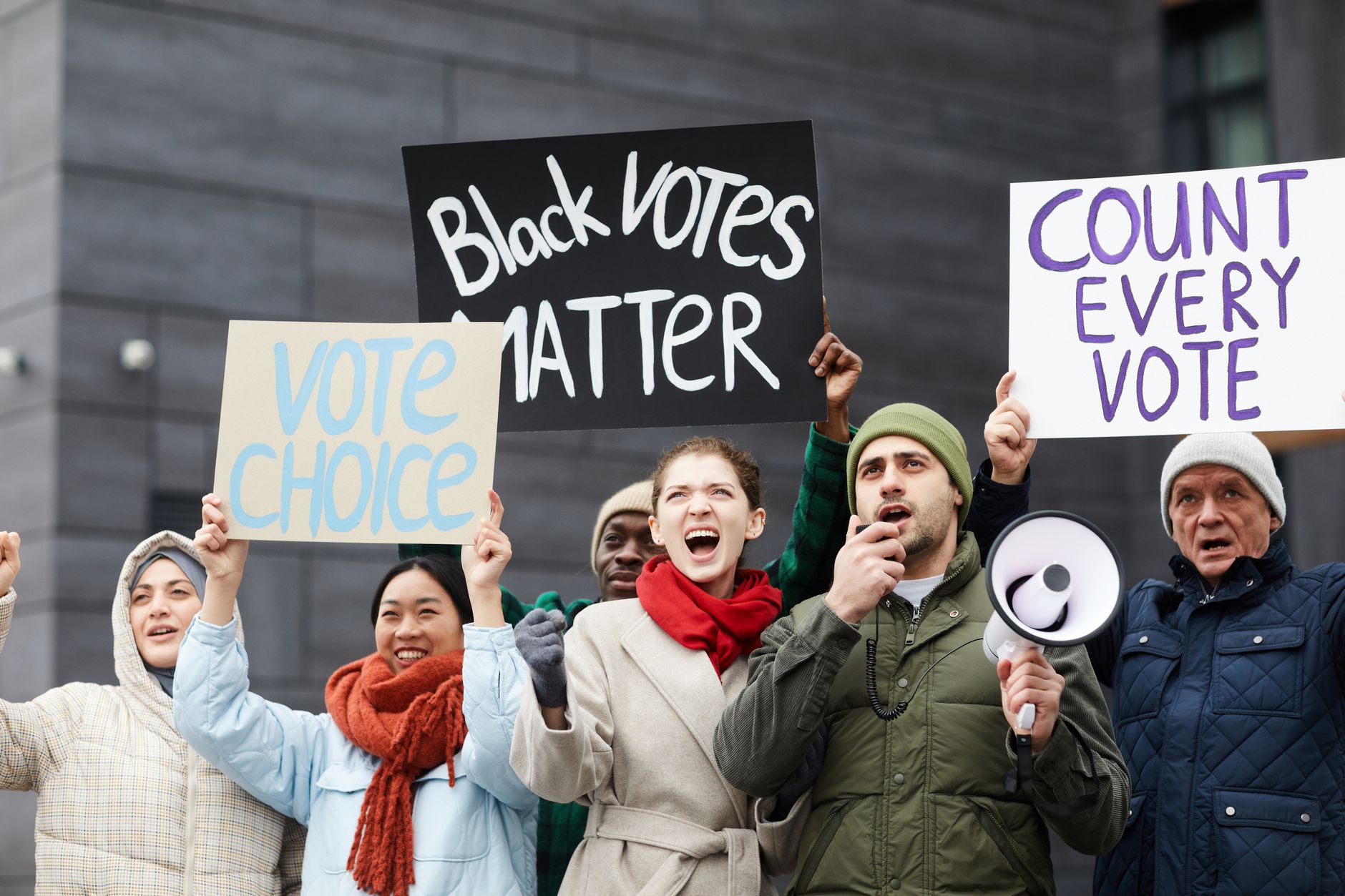 A protest scene where individuals are holding signs advocating for free speech rights. — free speech debate