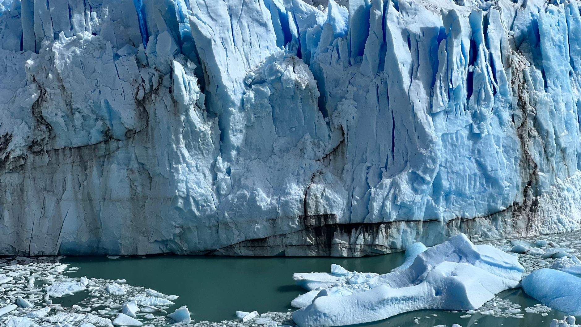 A split image illustrating the effects of climate change, featuring melting ice caps on one side and extreme weather event…