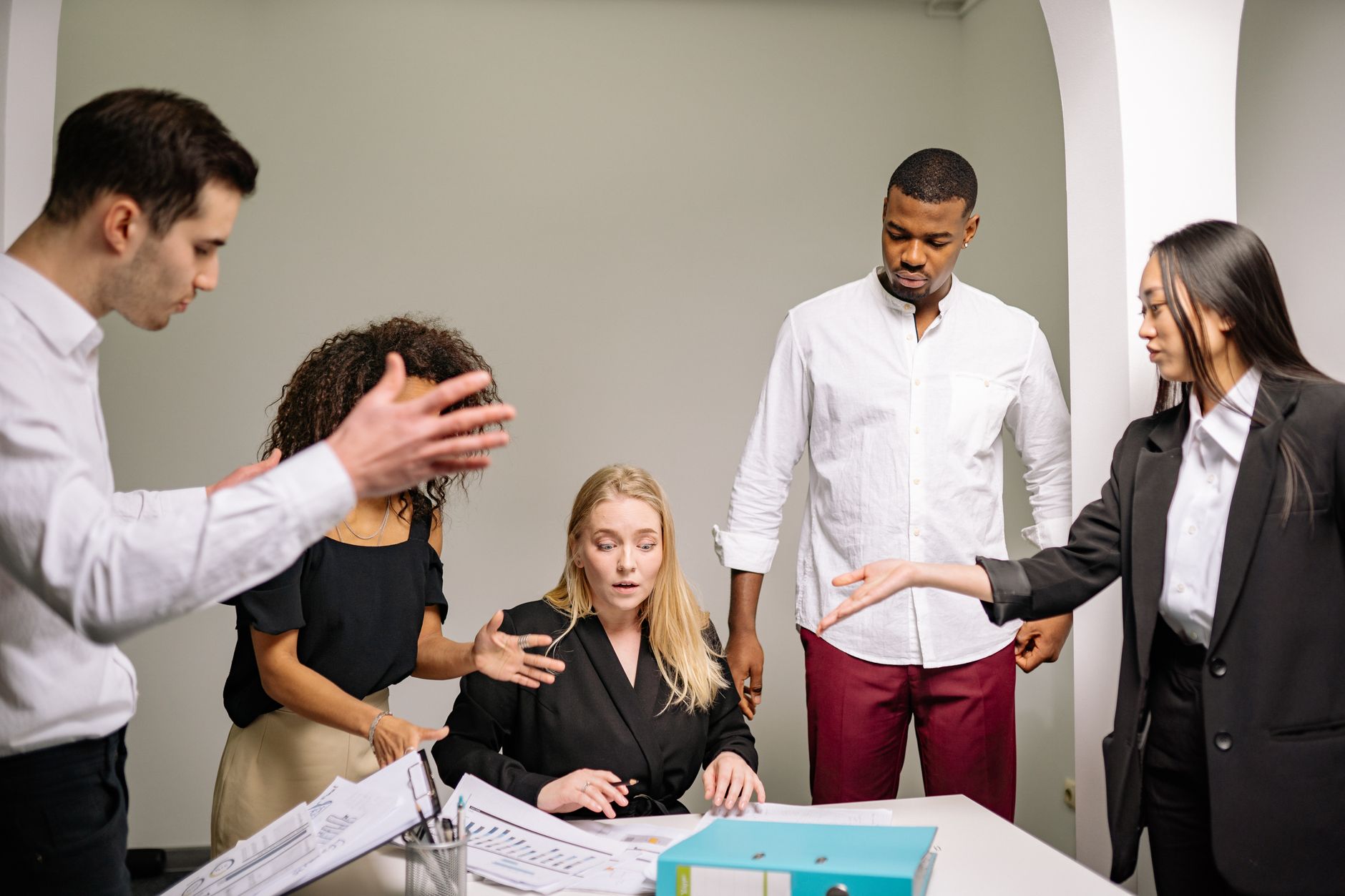 Image showing a diverse group of employees engaging in a debate during a meeting. — debate skills workplace