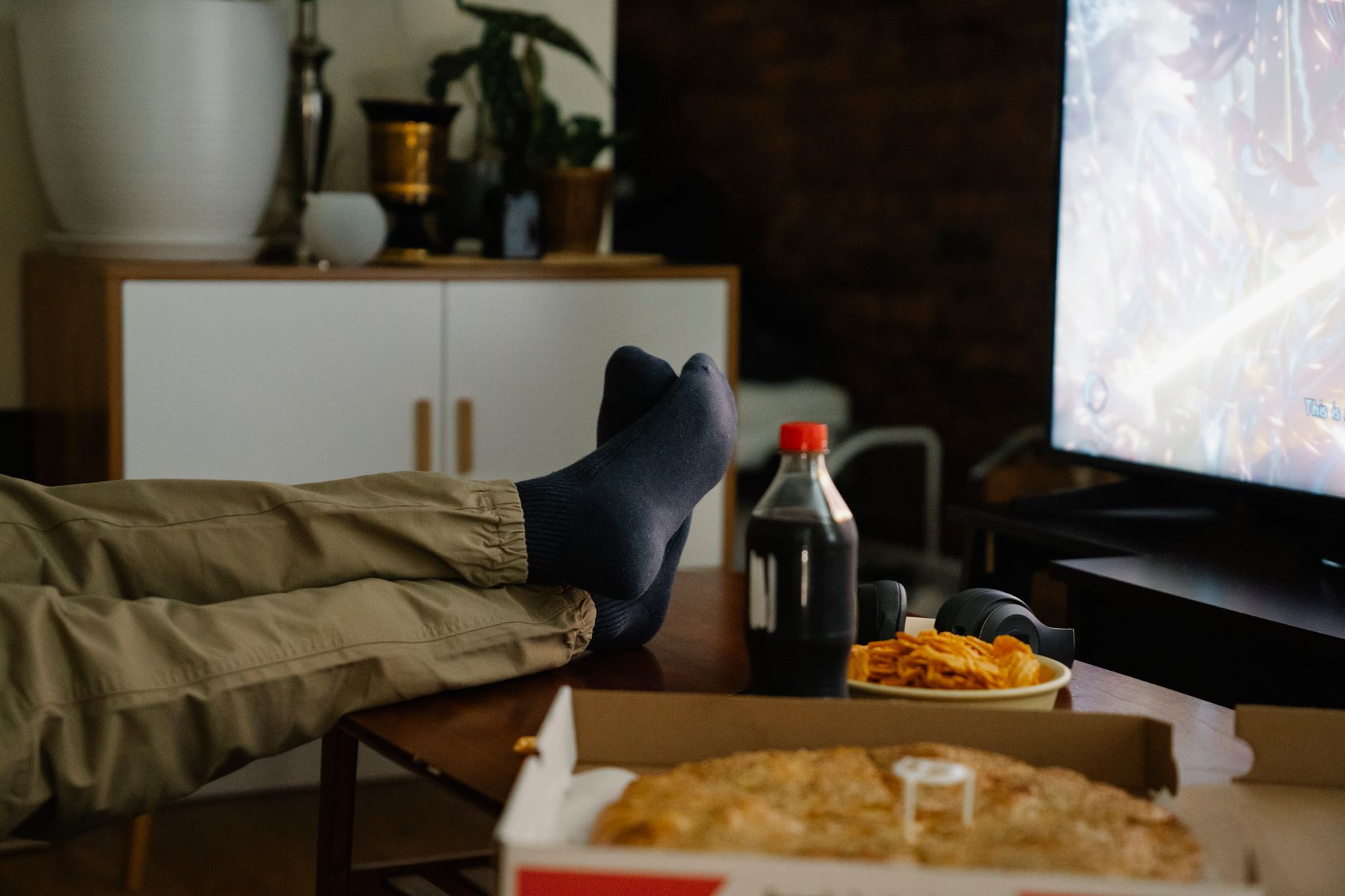 Photo of a child watching television with junk food advertisements in the background. — junk food advertising debate