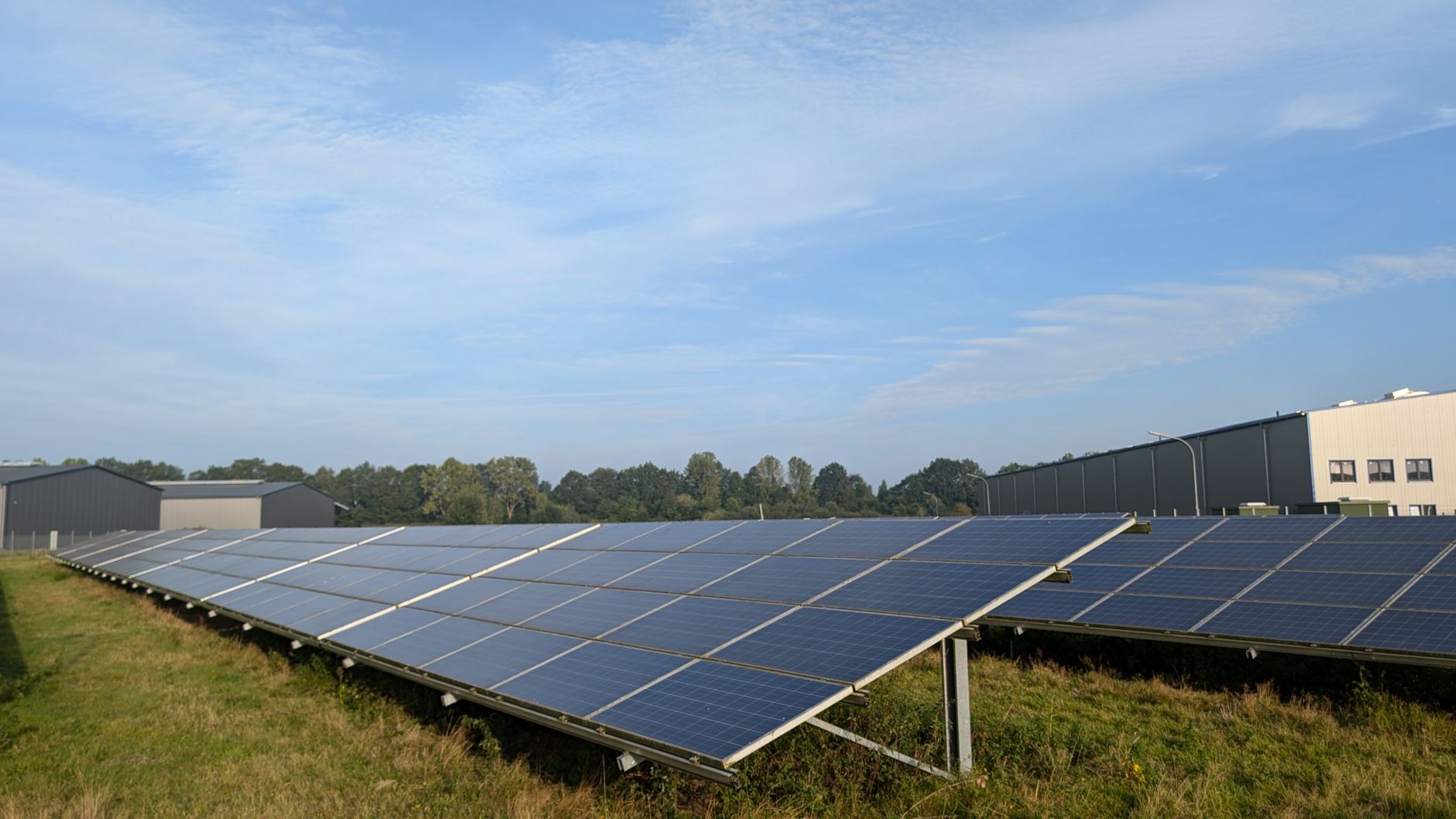 Photograph of a solar farm showcasing the implementation of renewable energy — renewable energy debate