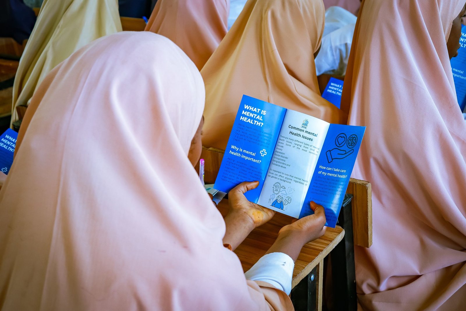 A classroom setting where an educational program on mental health is being conducted. — mental health debate