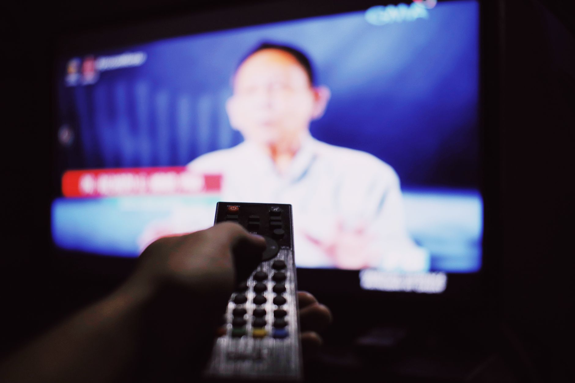 A clock with a TV remote beside it, symbolizing the balance between time management and media consumption. — tv debate