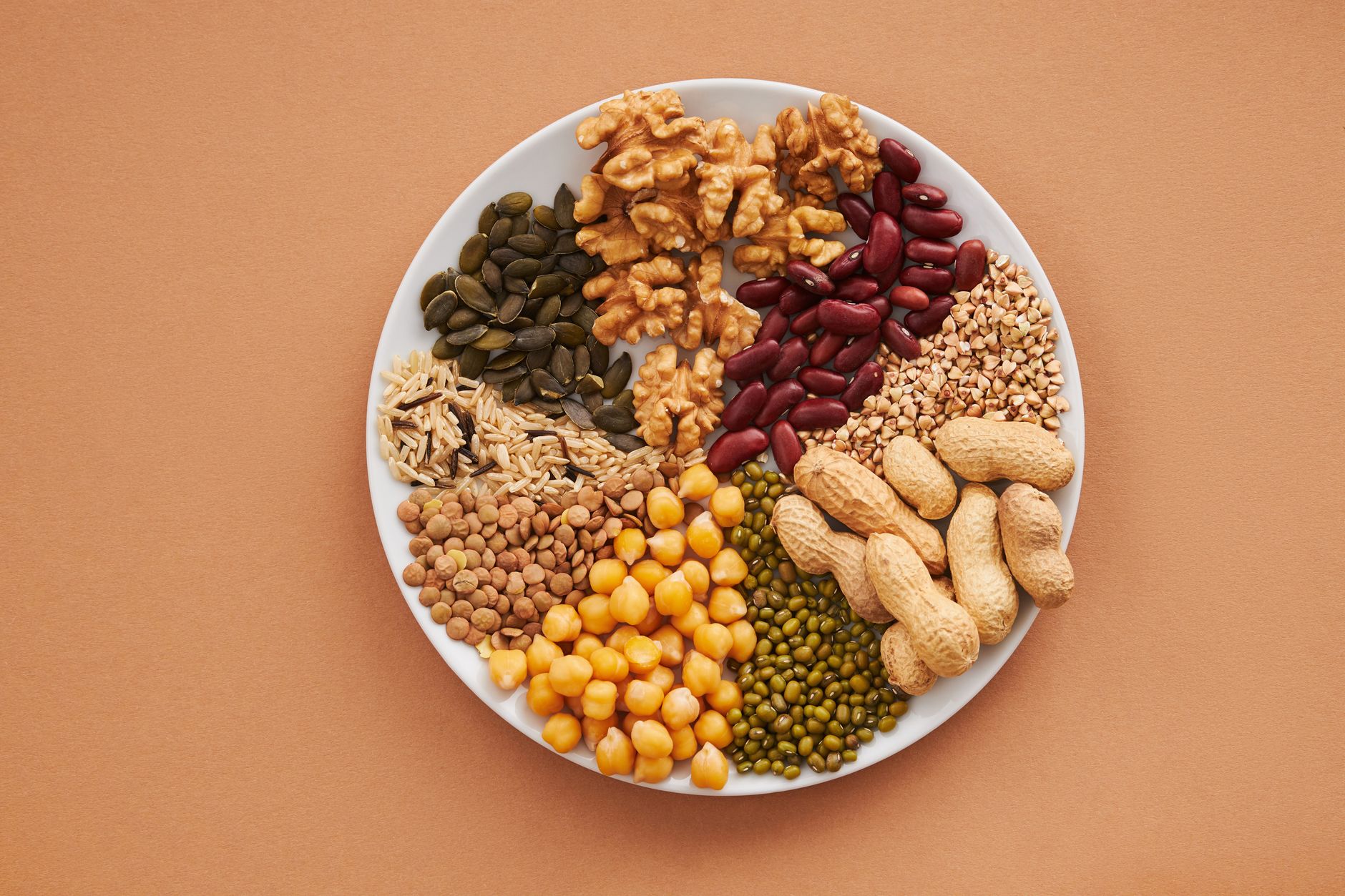 A colorful plate of vegan foods, showcasing a variety of fruits, vegetables, and grains for a balanced diet. — veganism …