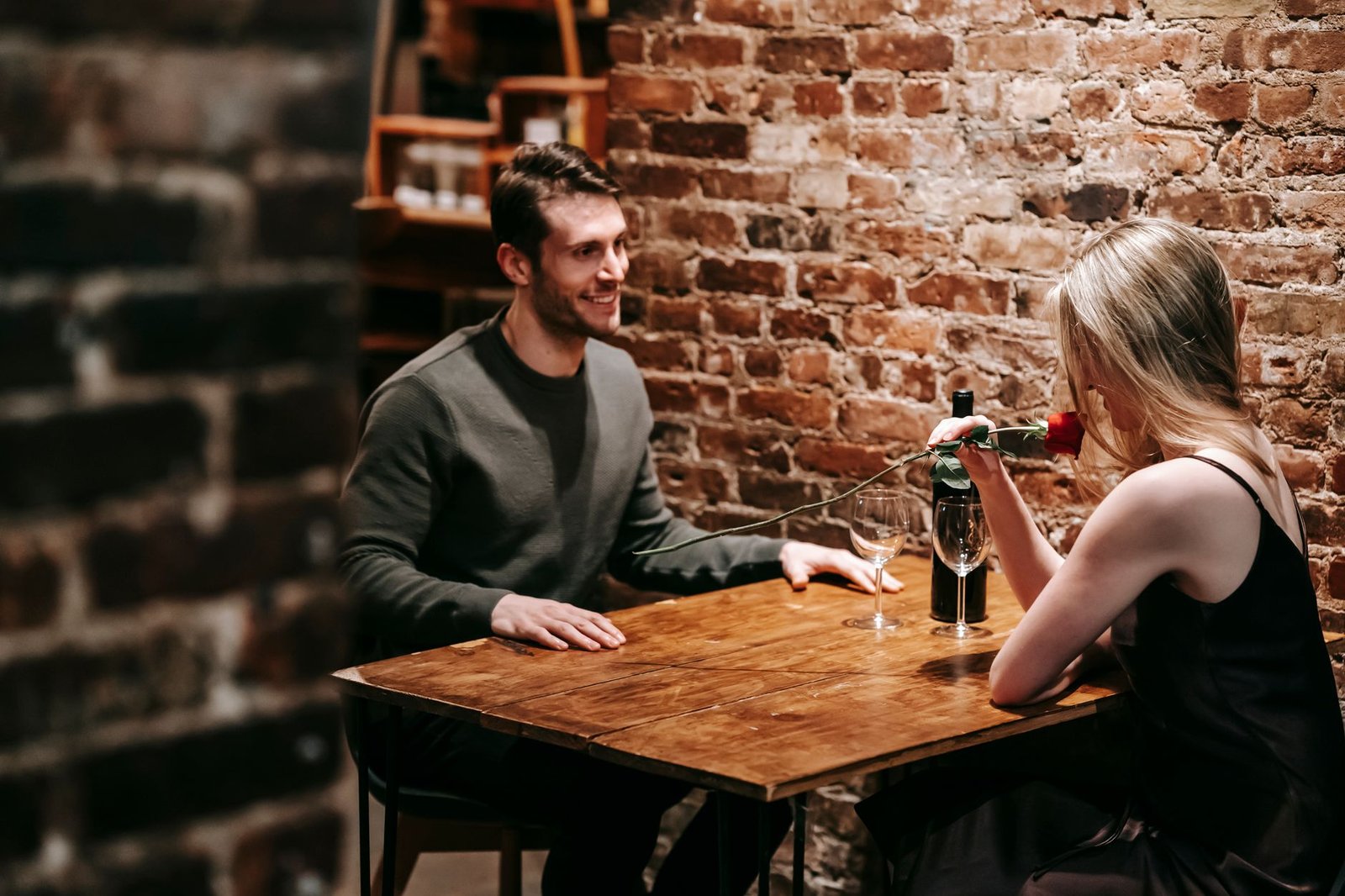 A couple enjoying a date in a restaurant, showcasing the essence of real-life dating in the dating debate.