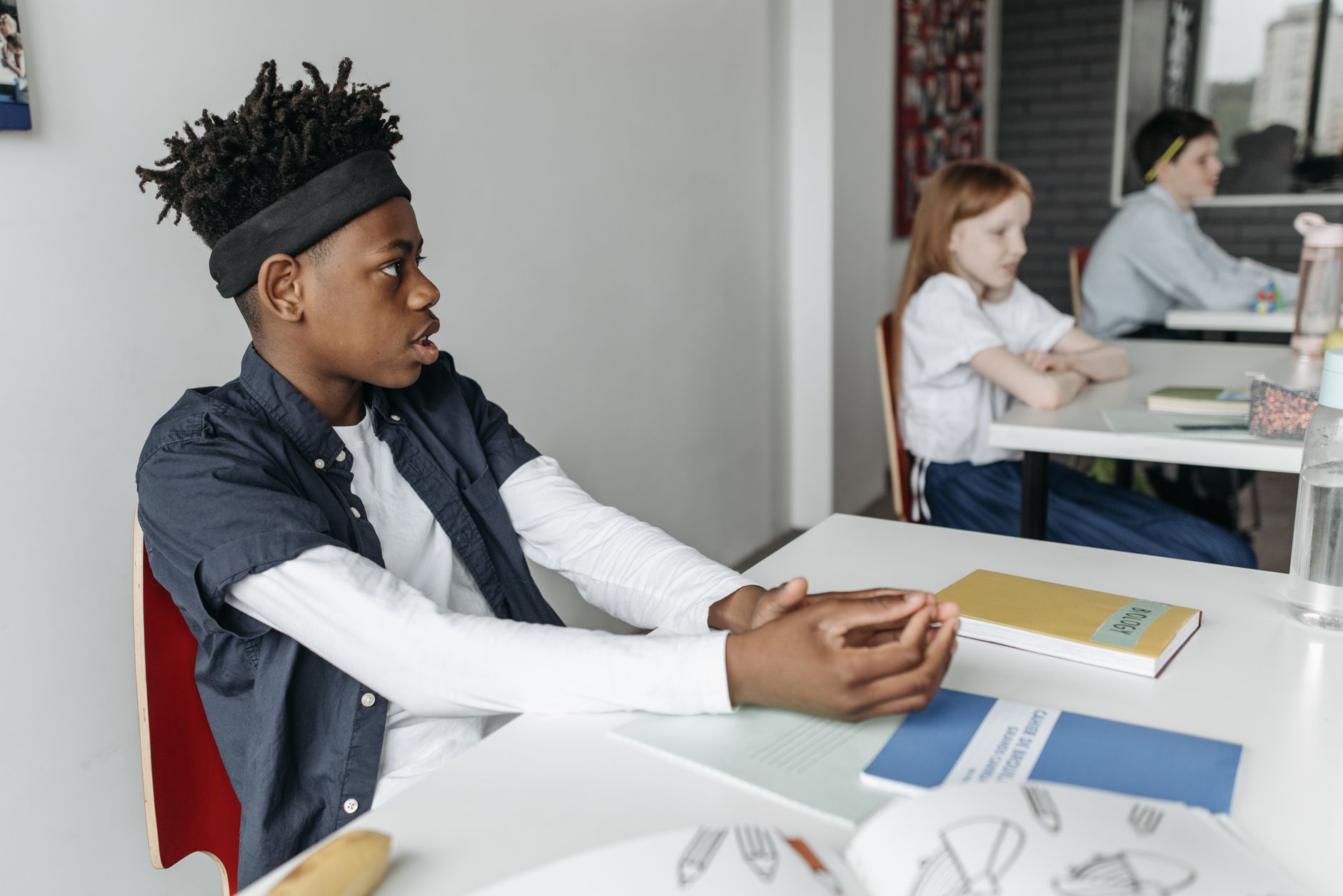 A group of students engaged in a lively debate, showcasing various expressions of concentration and enthusiasm. — debate…