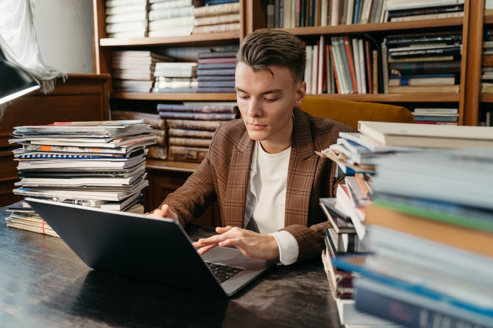 A person studying and researching for a debate on their laptop. — debate preparation
