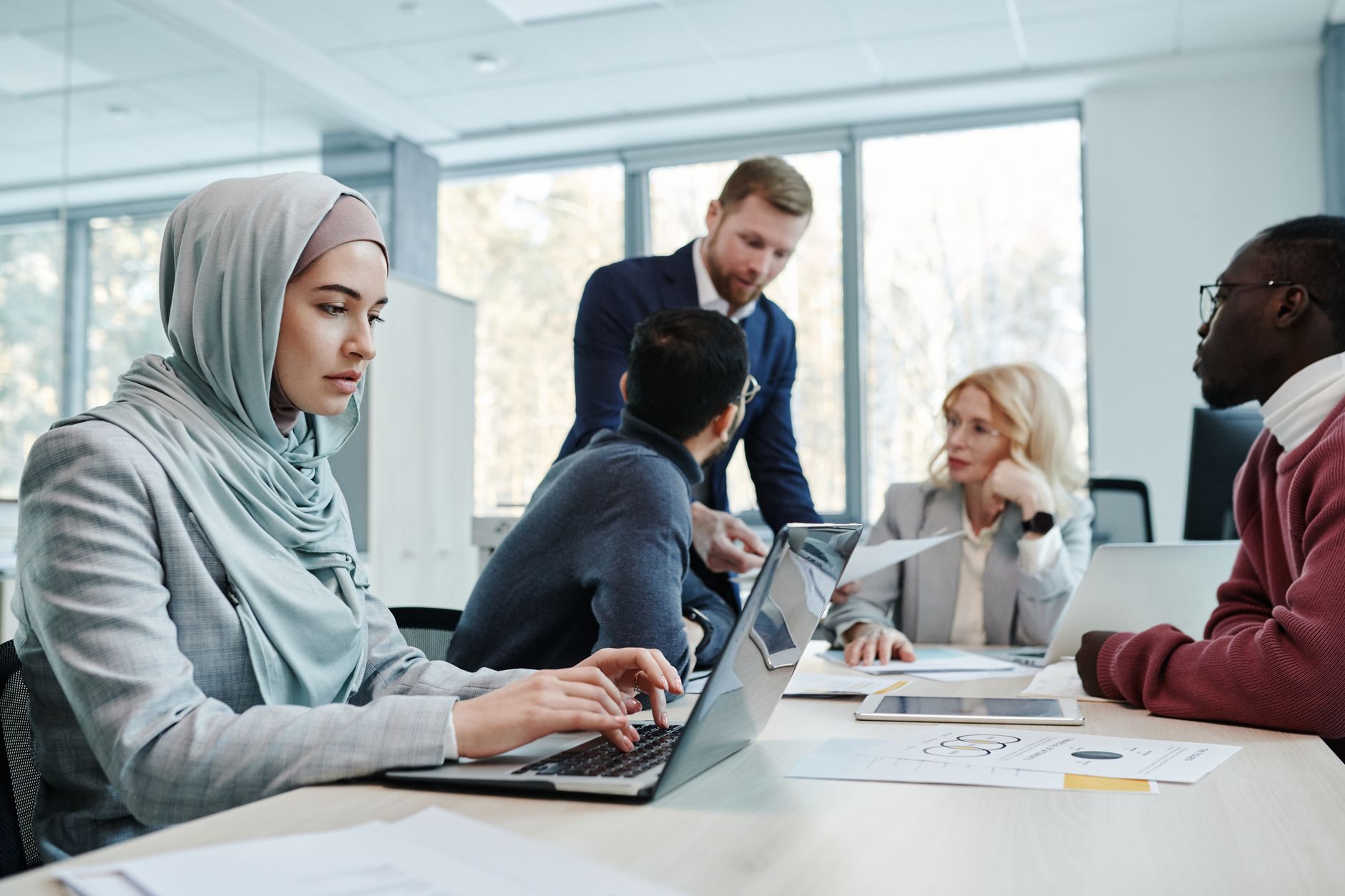 A photo showing diverse teams discussing AI technology's impact in a meeting room, emphasizing the importance of AI ethics in decision-making