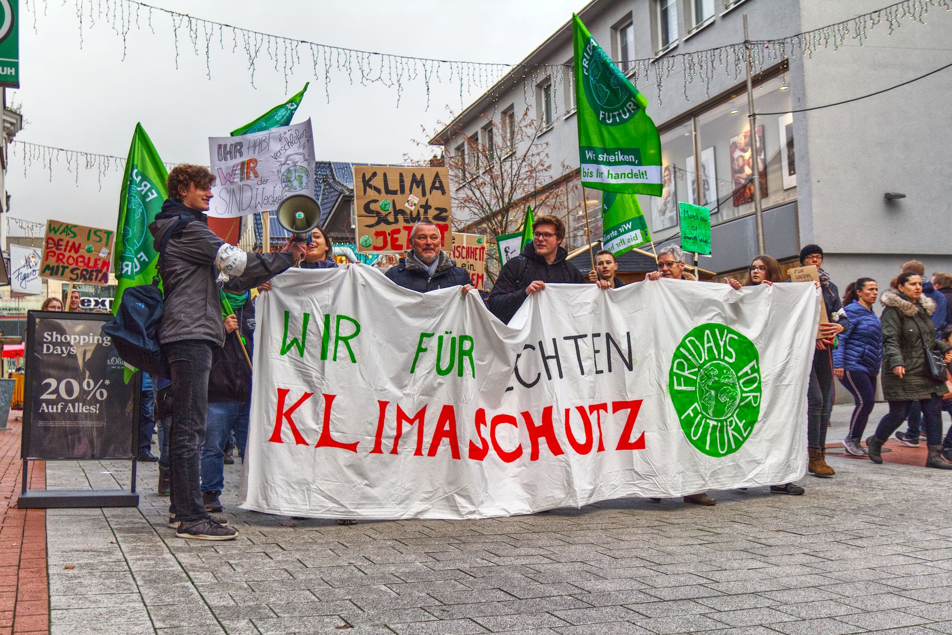 A photograph of climate activists engaging in a discussion, symbolizing community involvement in the climate change debate.