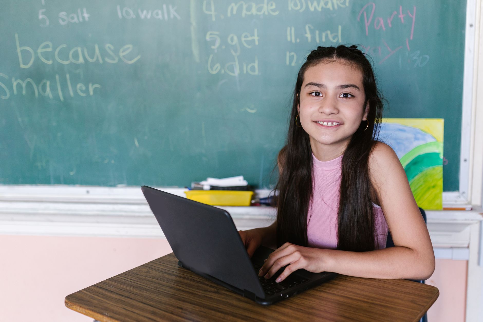 A split image showing a student using a laptop for online learning on one side and a classroom filled with students on the other side to illustrate the education debate.