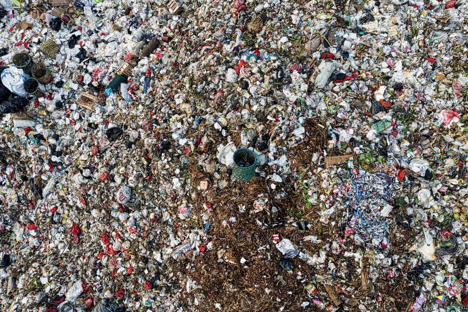 A stark visual representation of fast fashion waste in landfills. — fast fashion impact