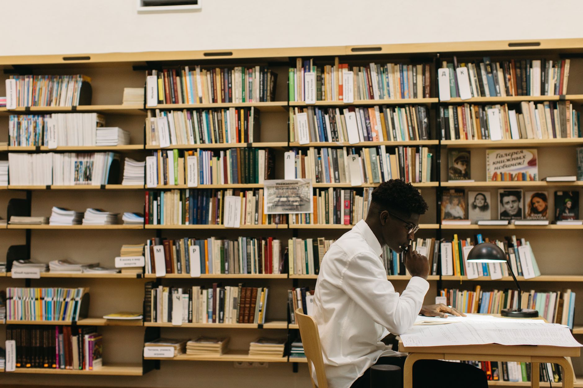 A student researching debate topics at a library, focusing on credible sources. — debate preparation