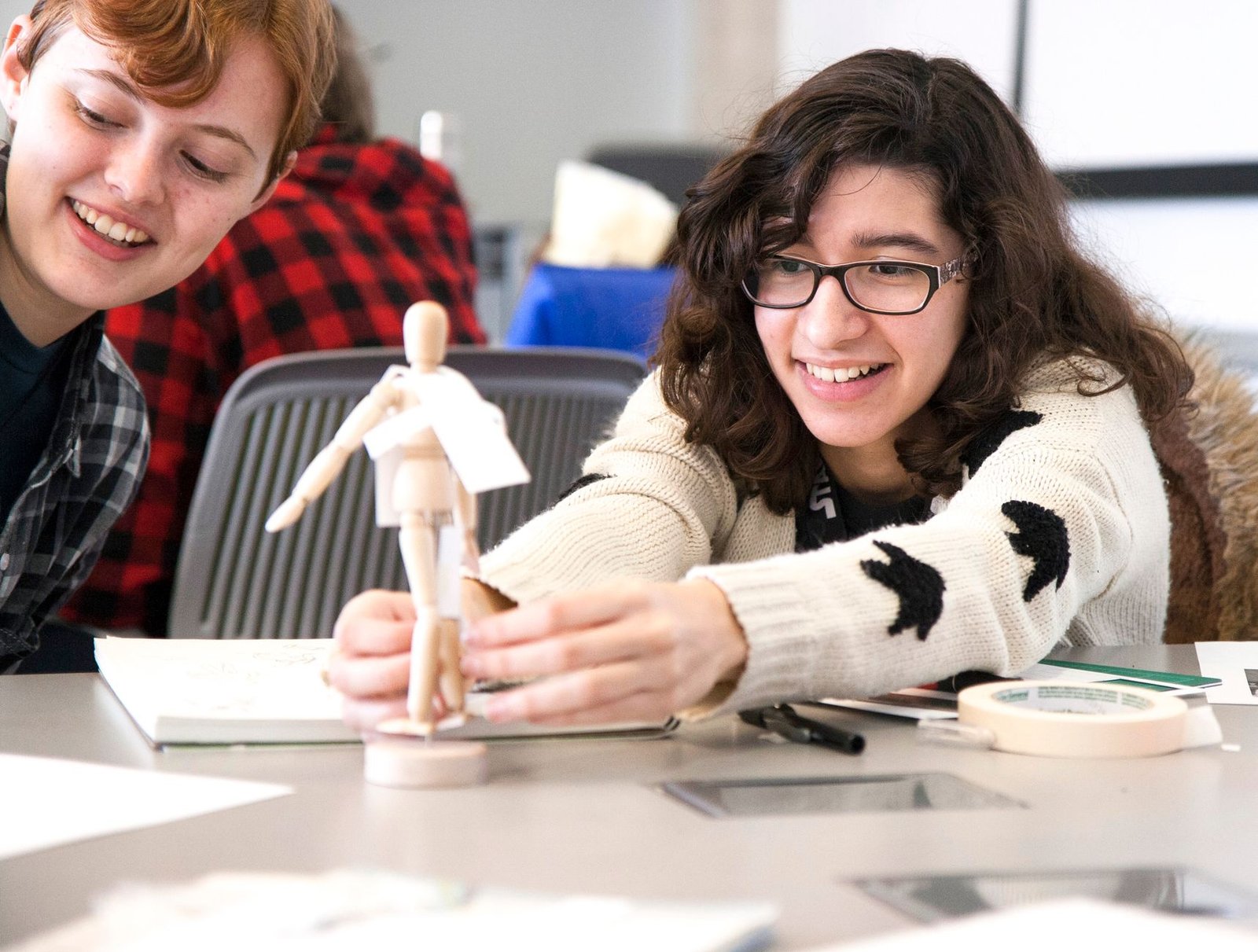 A classroom setting showing students engaged in a creative project. — education creativity debate